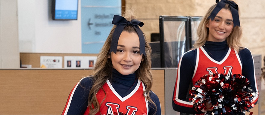 Two Cheerleaders Smiling at the Camera 