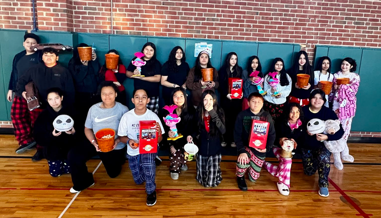 Group of students smiling with gift bags in hand 