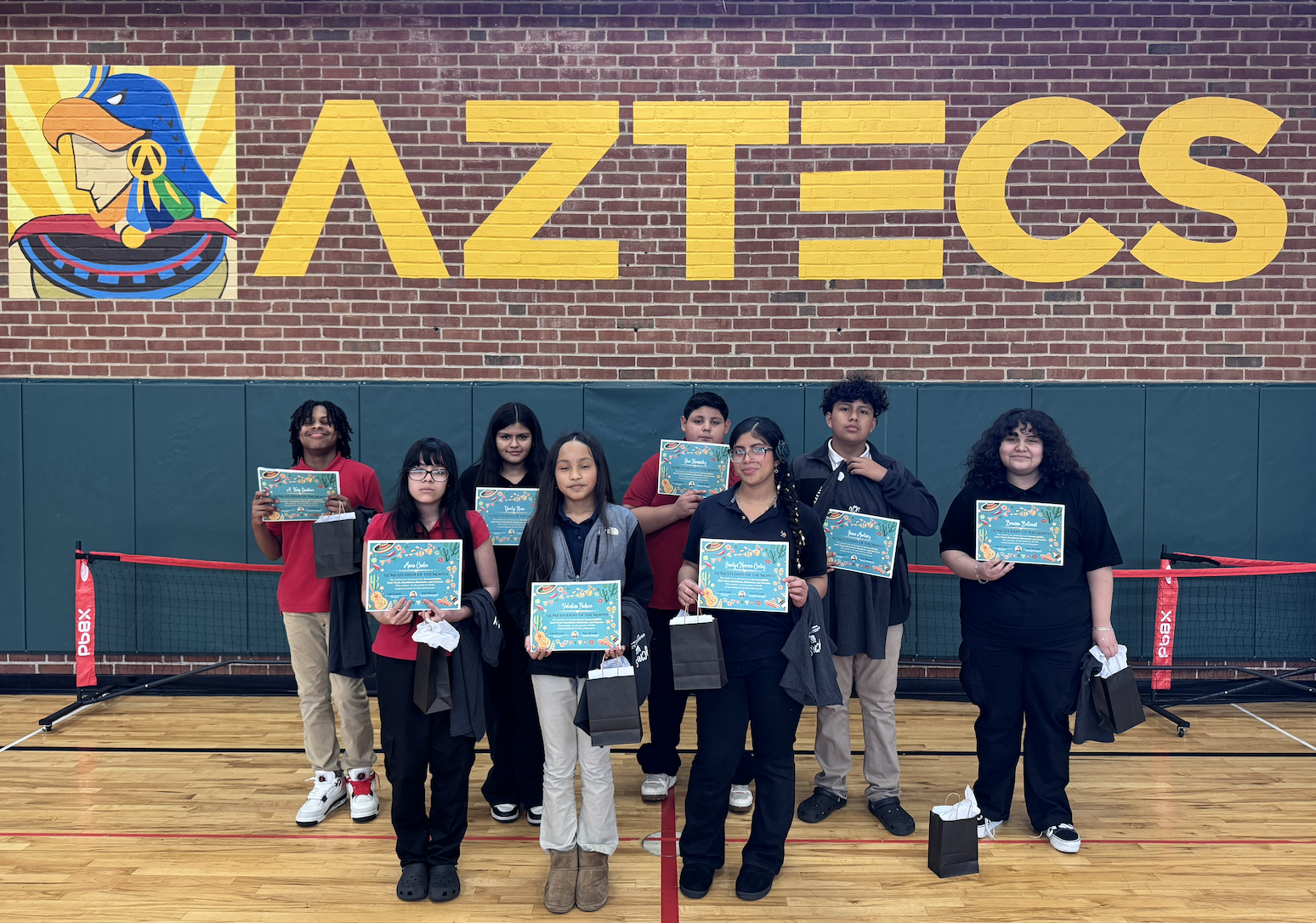 Group of students holding up awards 