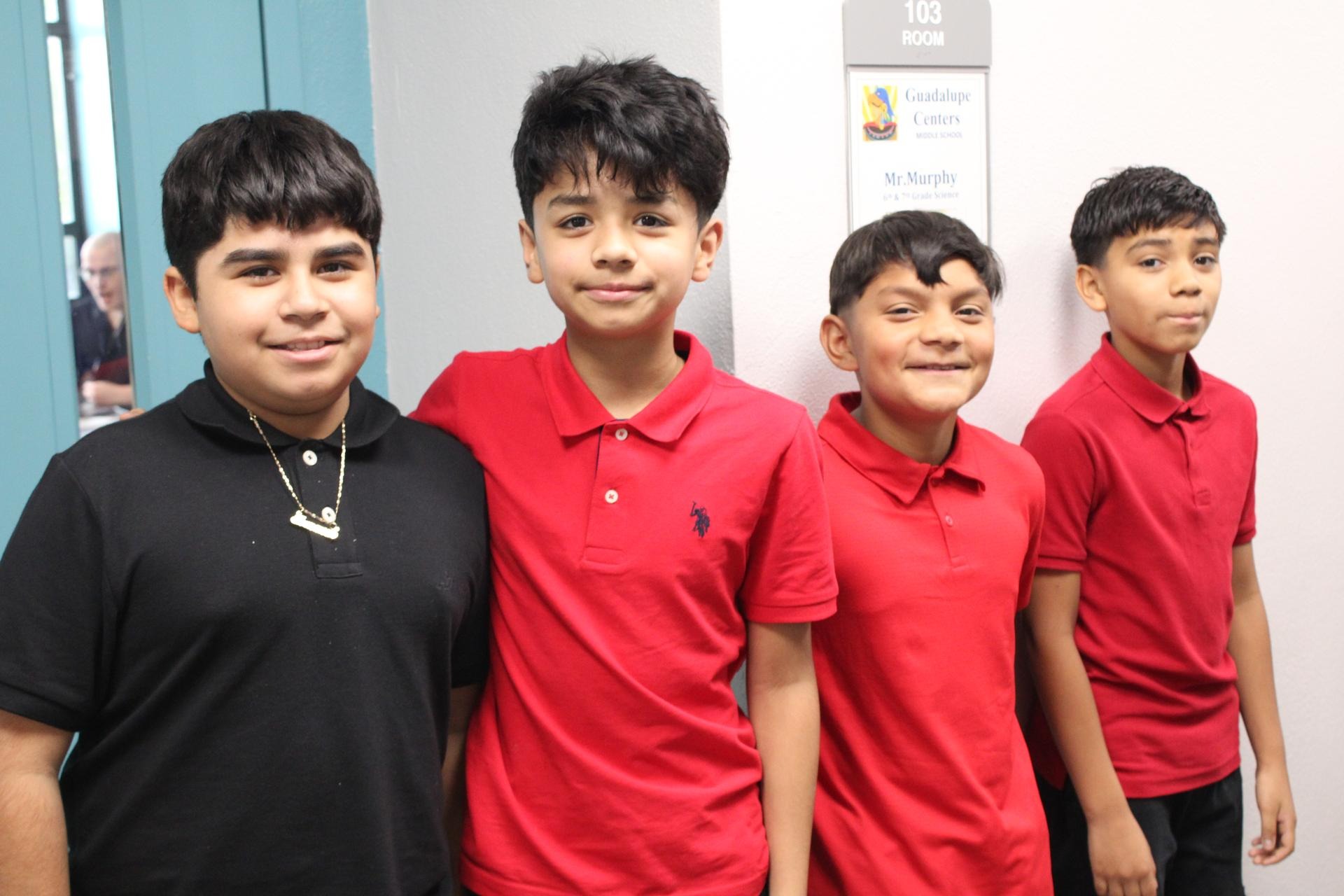Four students smiling at the camera