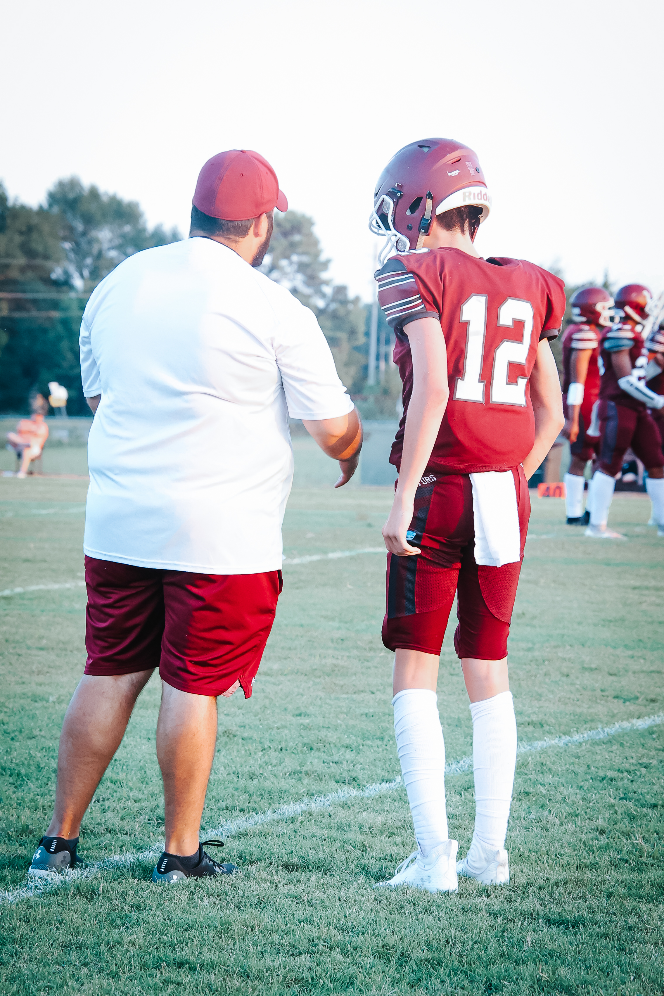 Player with coach talking