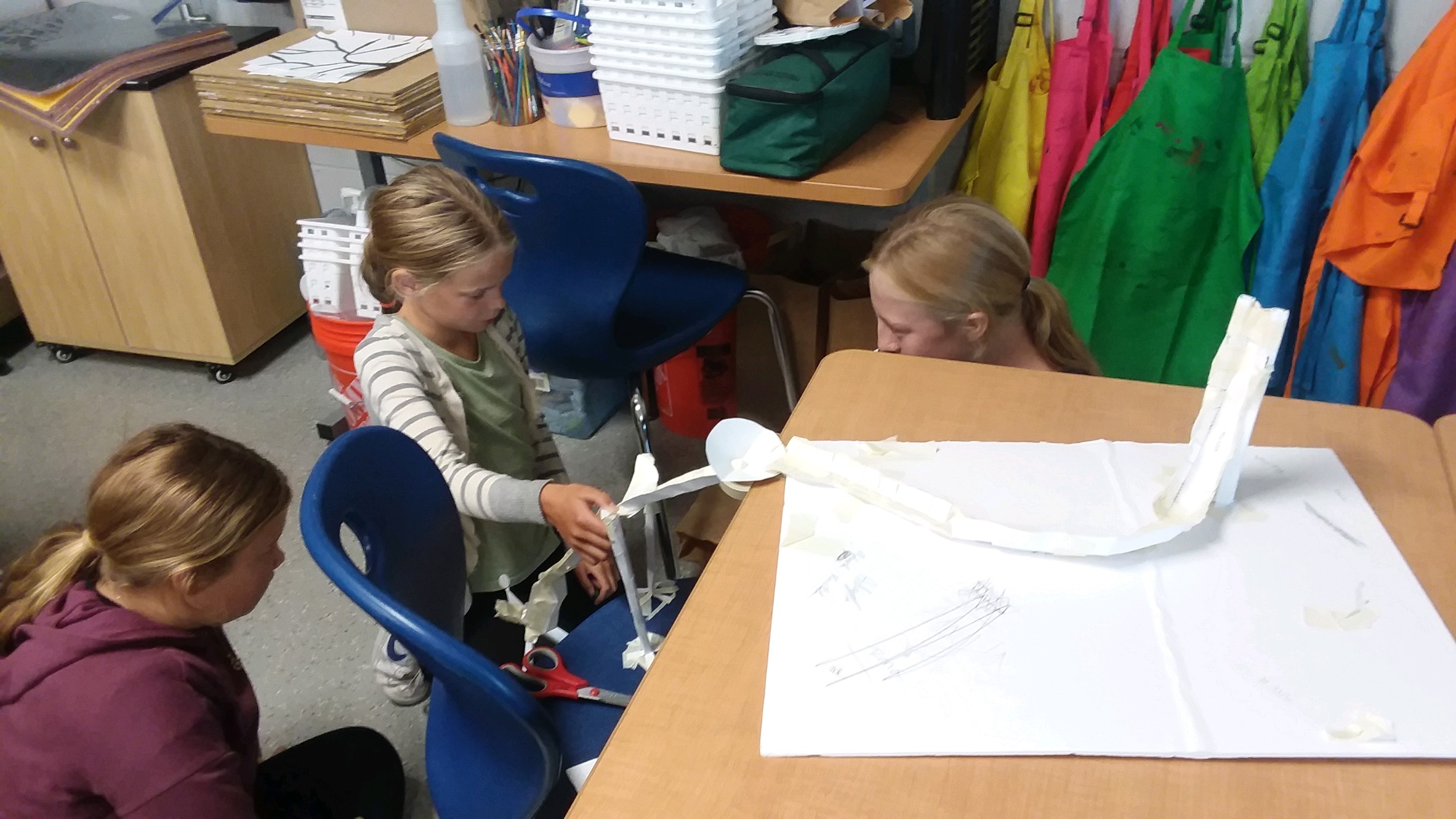 Students learn about forces and energy by designing and testing a paper rollercoaster.