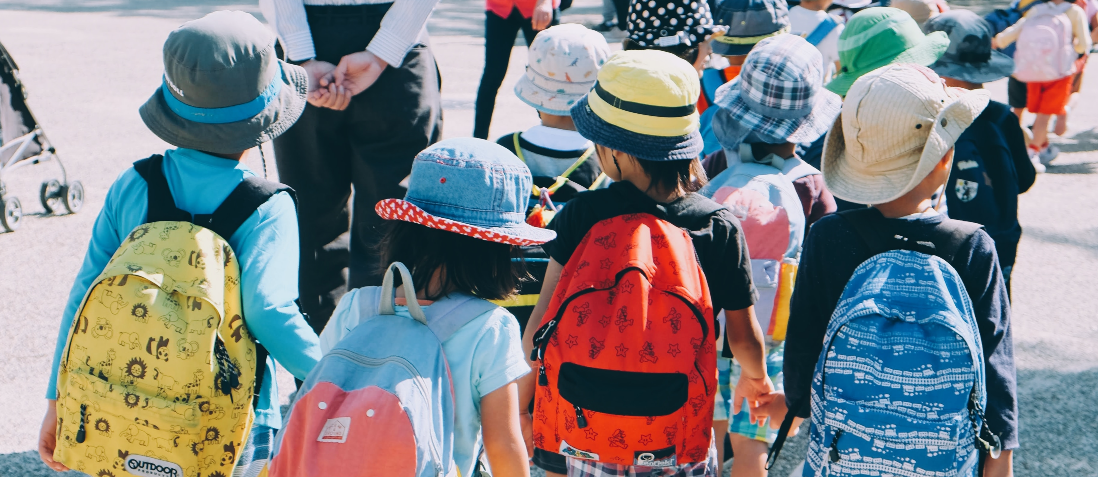 4 students walking with backpacks