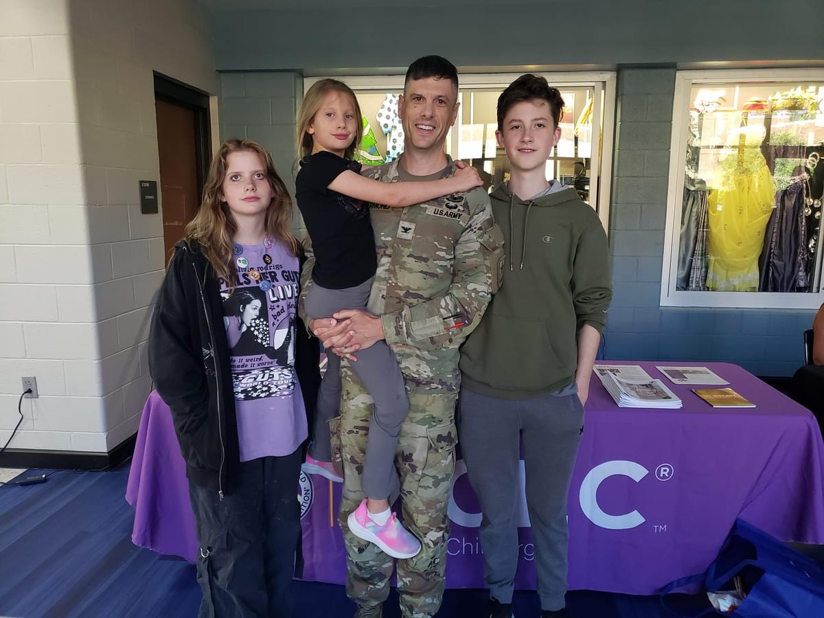 A family of four poses at New Century.