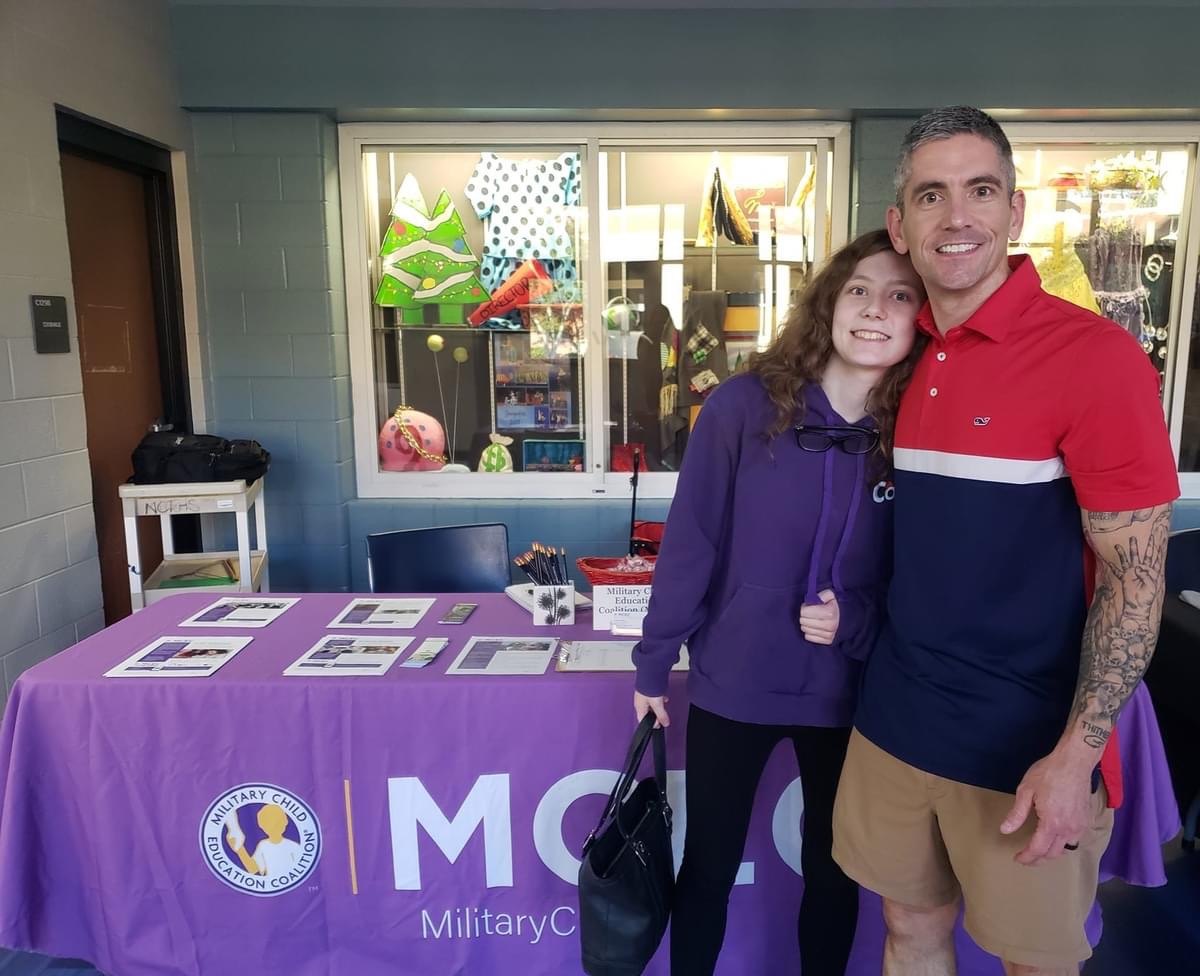 A father and daughter pose at New Century.