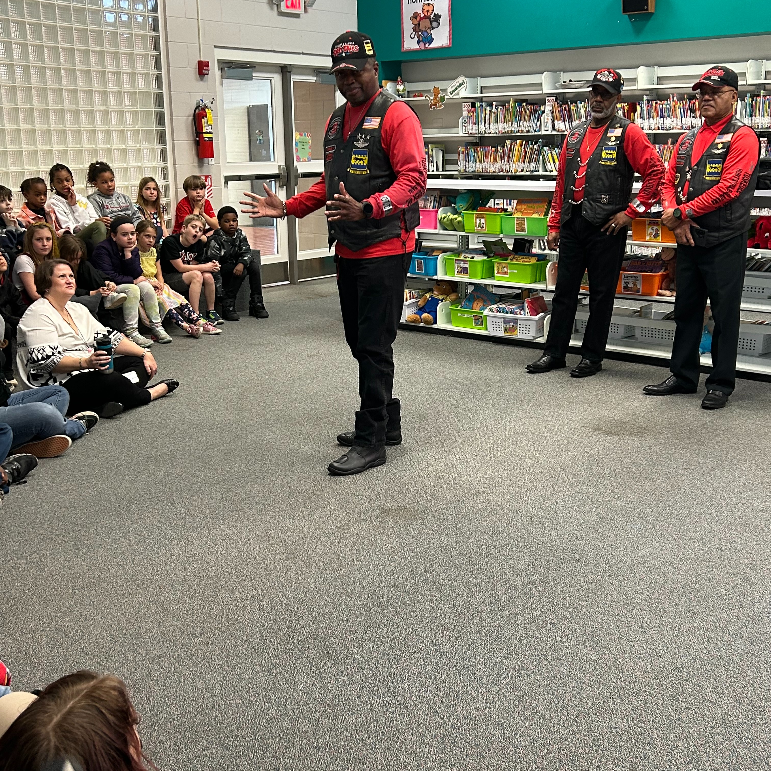 Tuskegee Airmen Motorcycle Club veteran presenting to students.