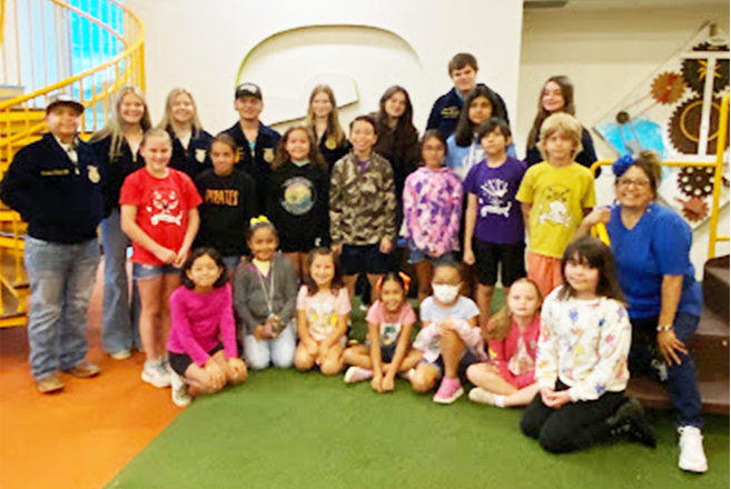 High School FFA Officers speak to Elementary Student Council students about officer roles and parliamentary procedures for meetings.