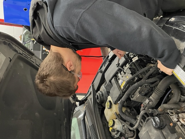 student working on an engine