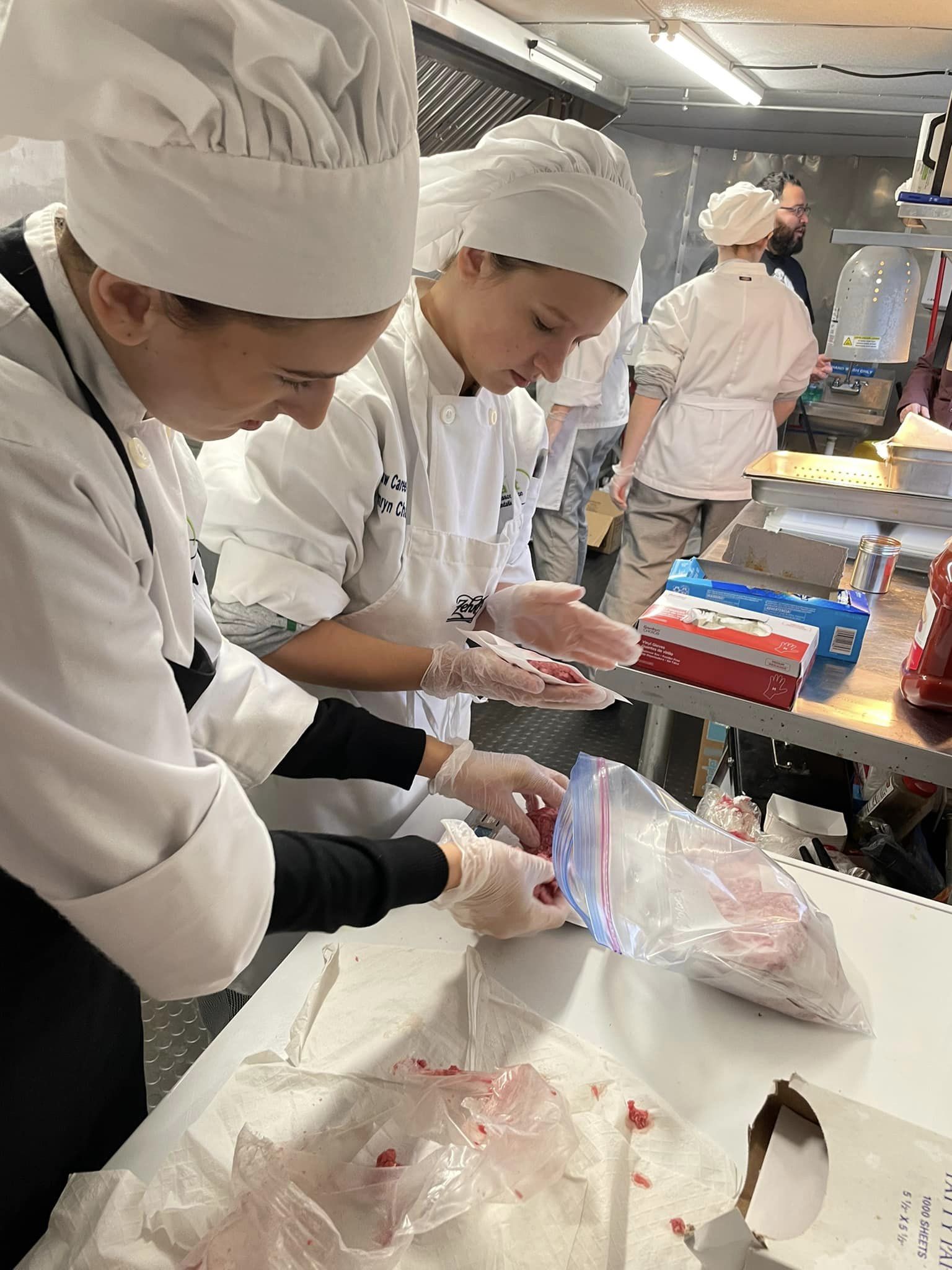 culinary students prepping chicken