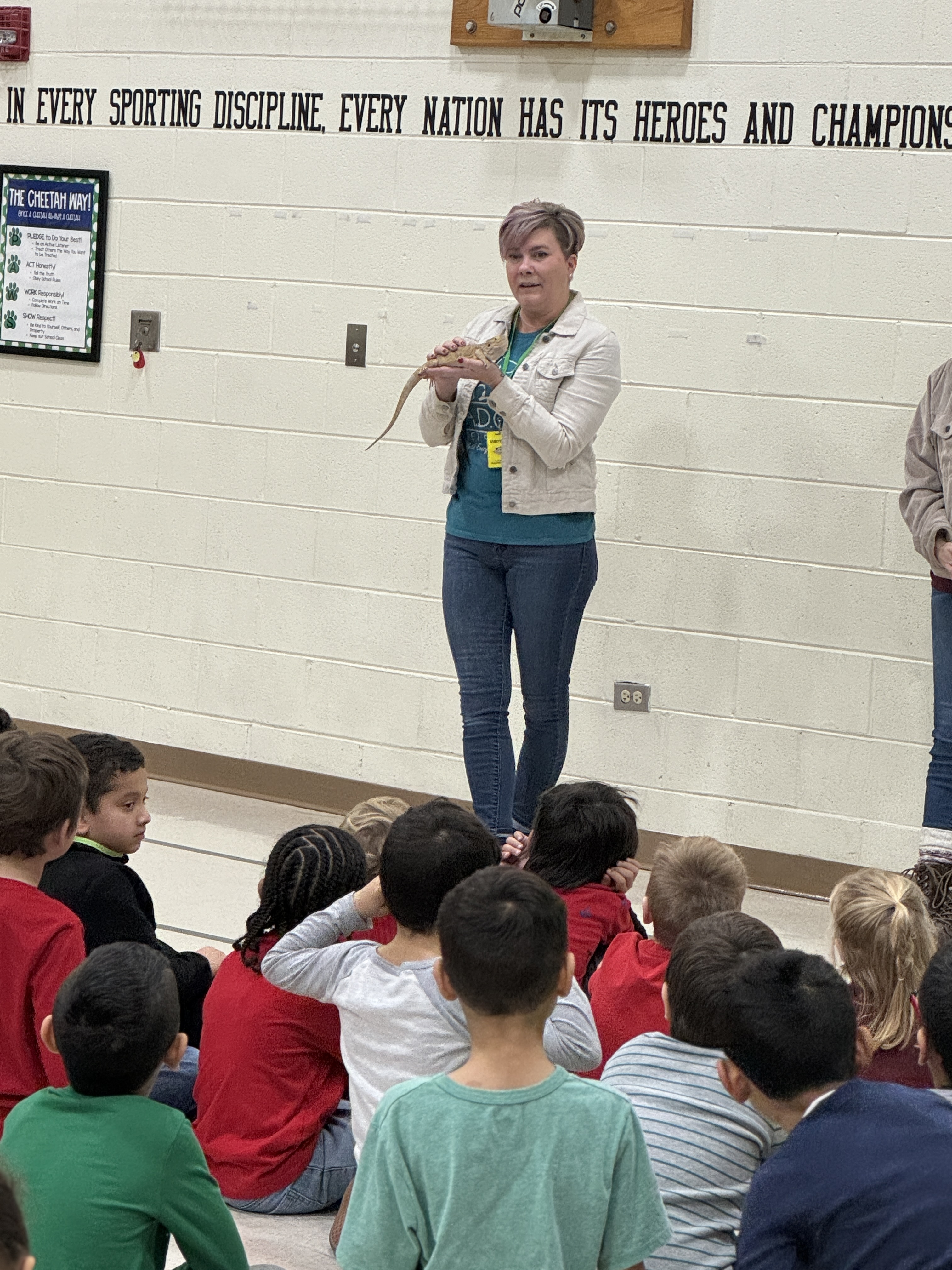 ADOPT Assembly - Creekside Students learning about "Lizzo" the Bearded Dragon.