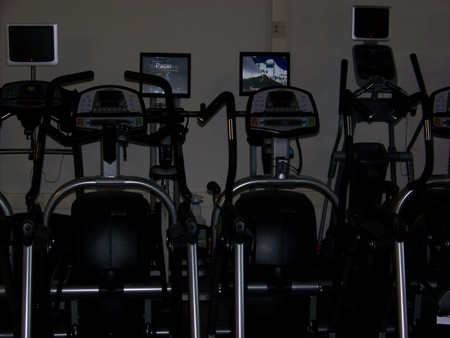 A couple of spinning bikes inside of the gym.