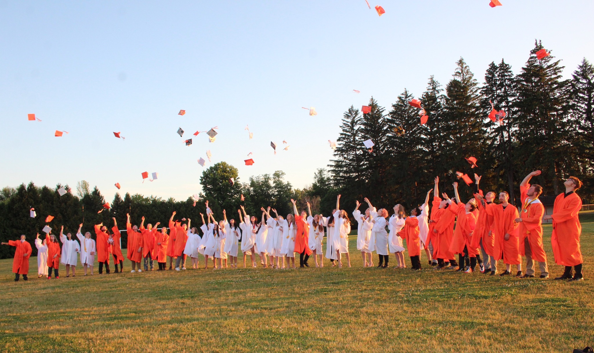 lyndonville students tossing graduation caps in the air