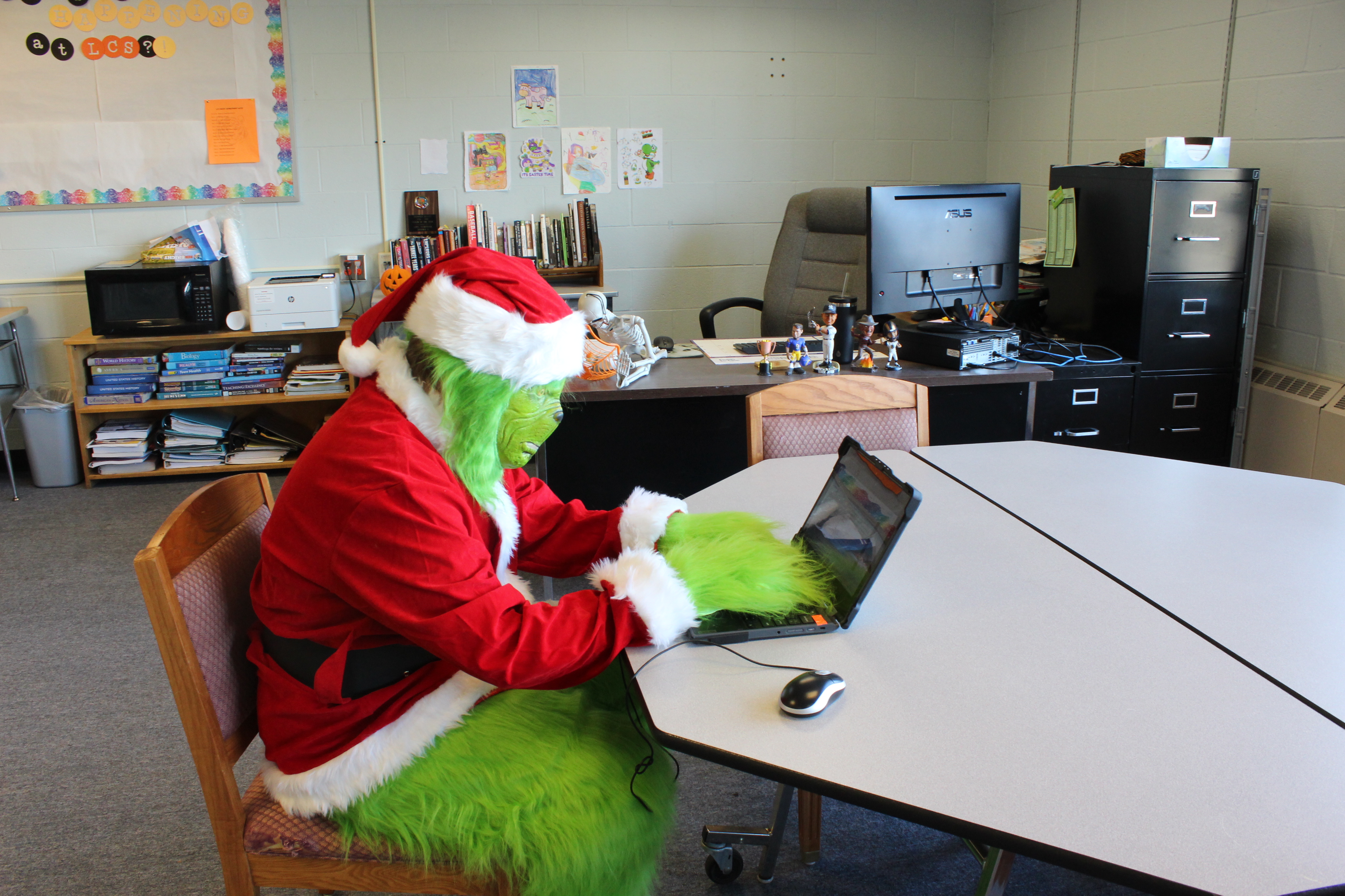 The Grinch working on laptop