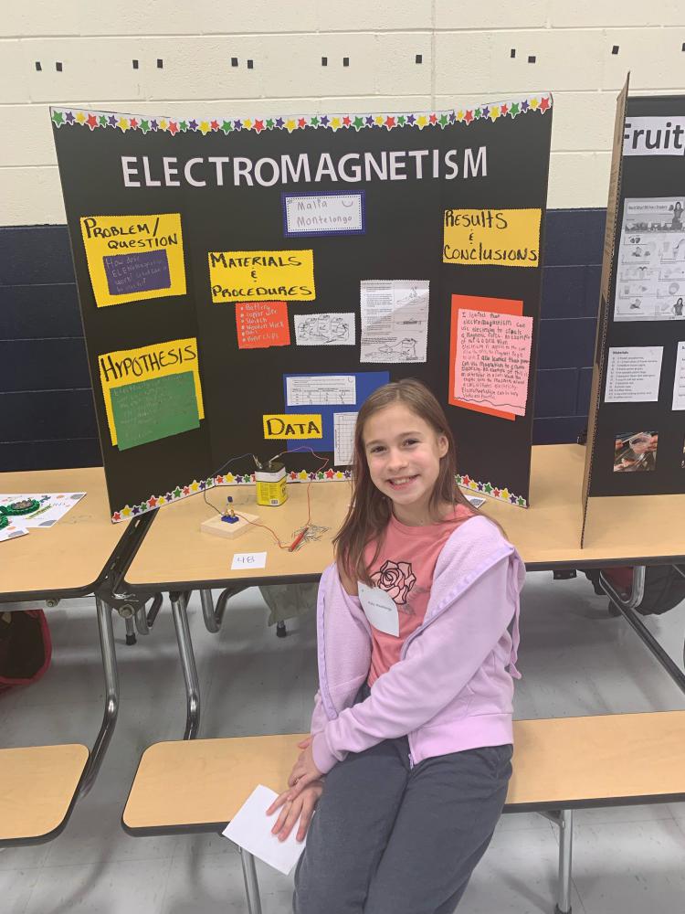 student showing their science project