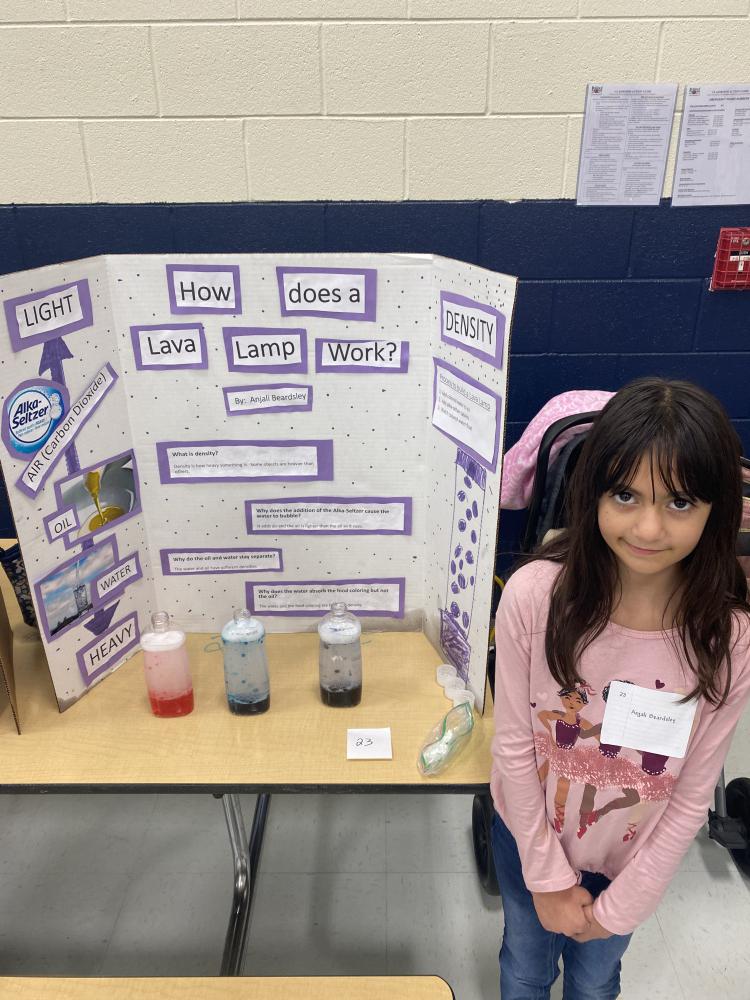 student showing their science project