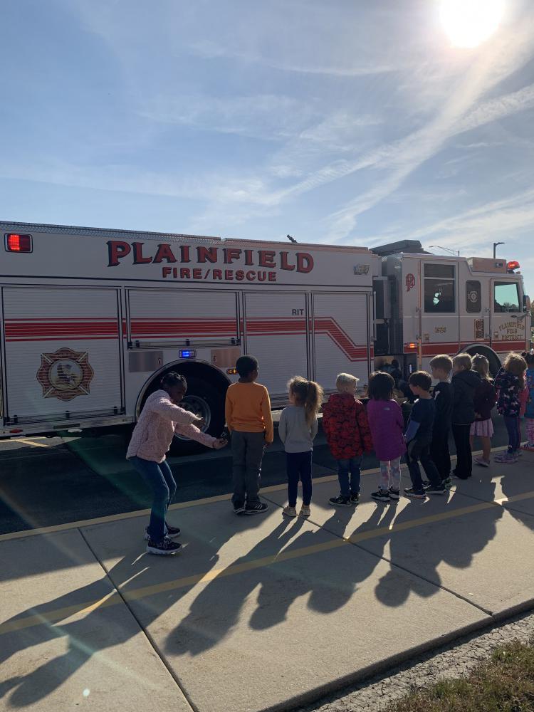 students at a demonstration on fire truck