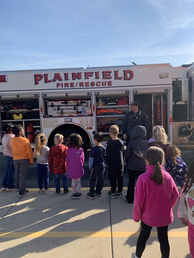 students at a demonstration on fire truck