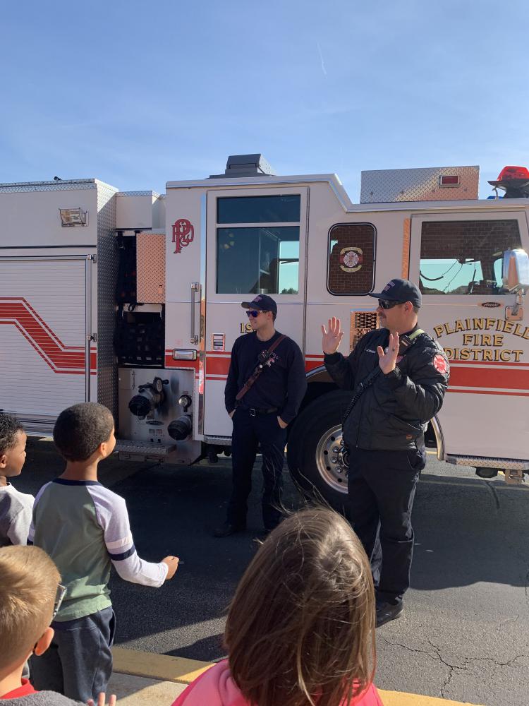 students at a demonstration on fire truck