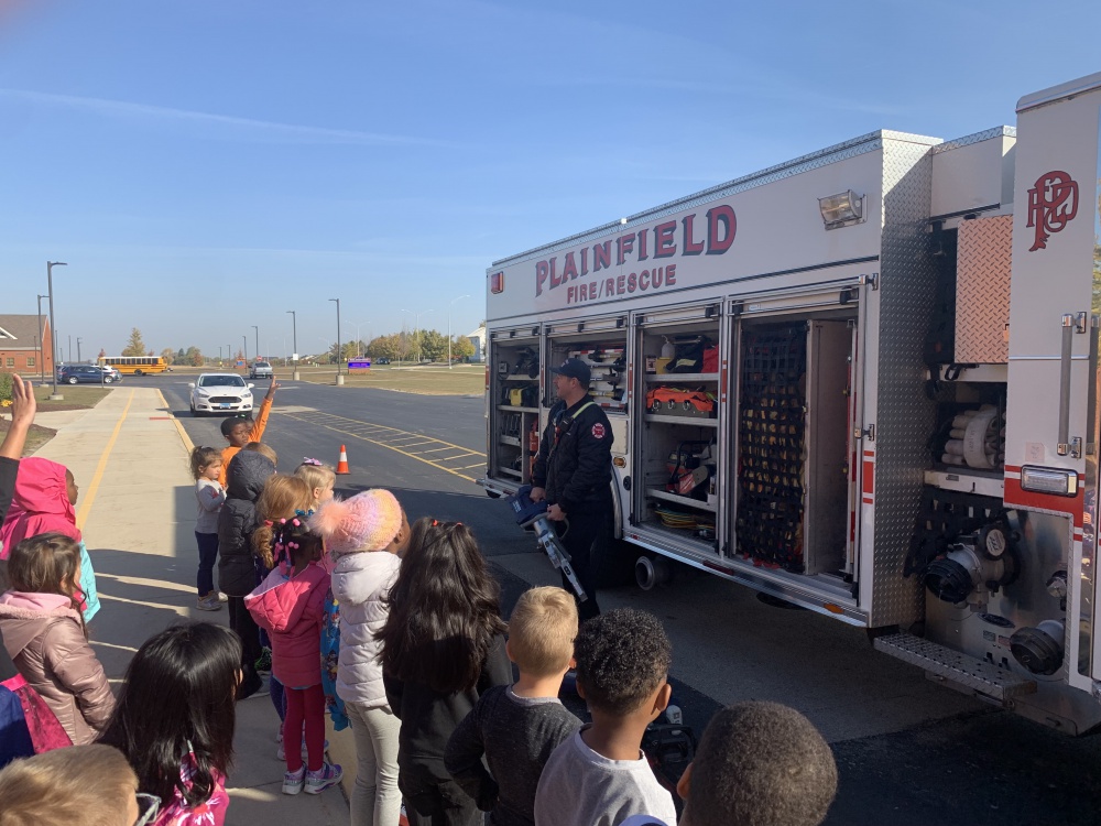 students at a demonstration on fire truck