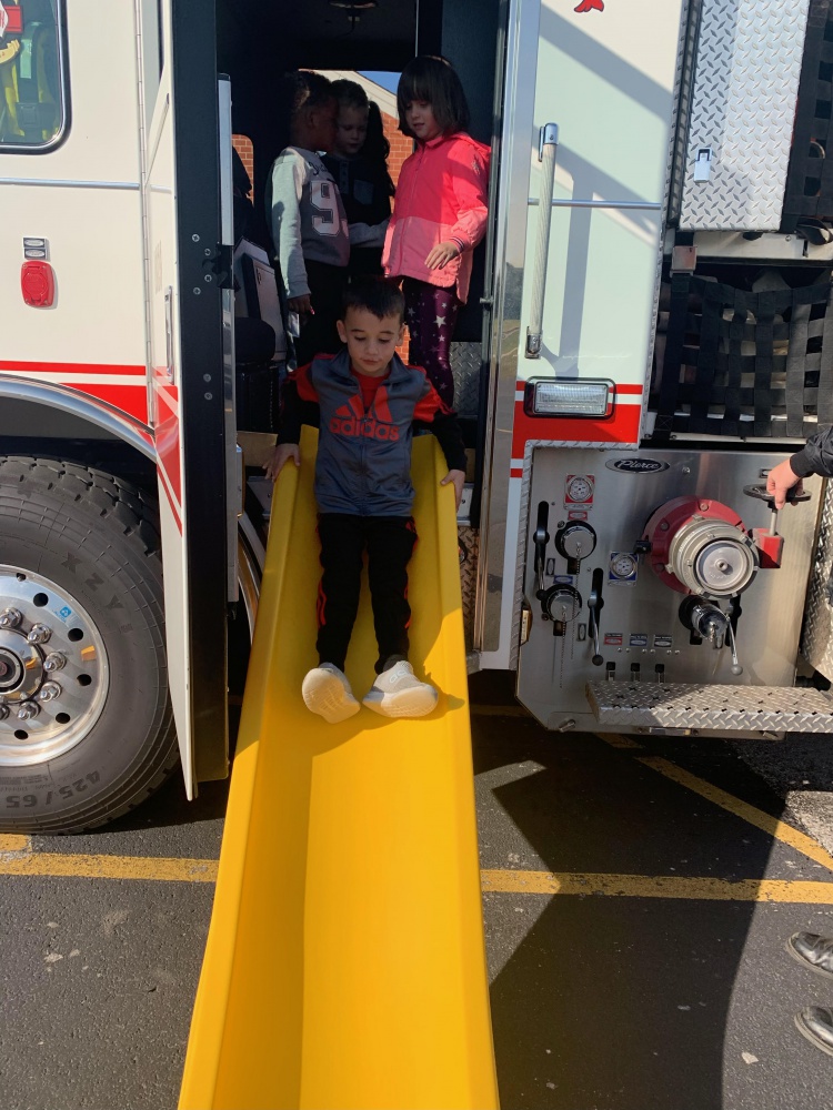 students at a demonstration on fire truck