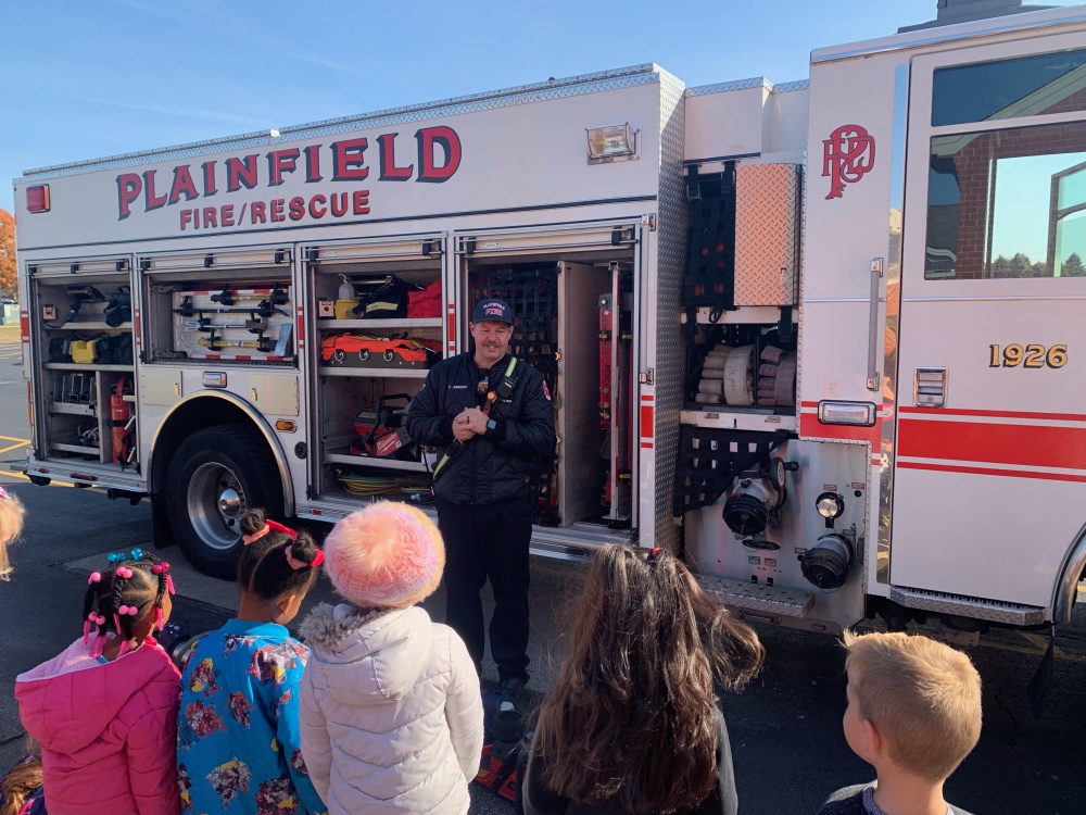 students at a demonstration on fire truck