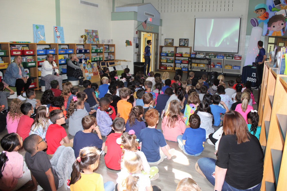 students together in a room watching demonstration