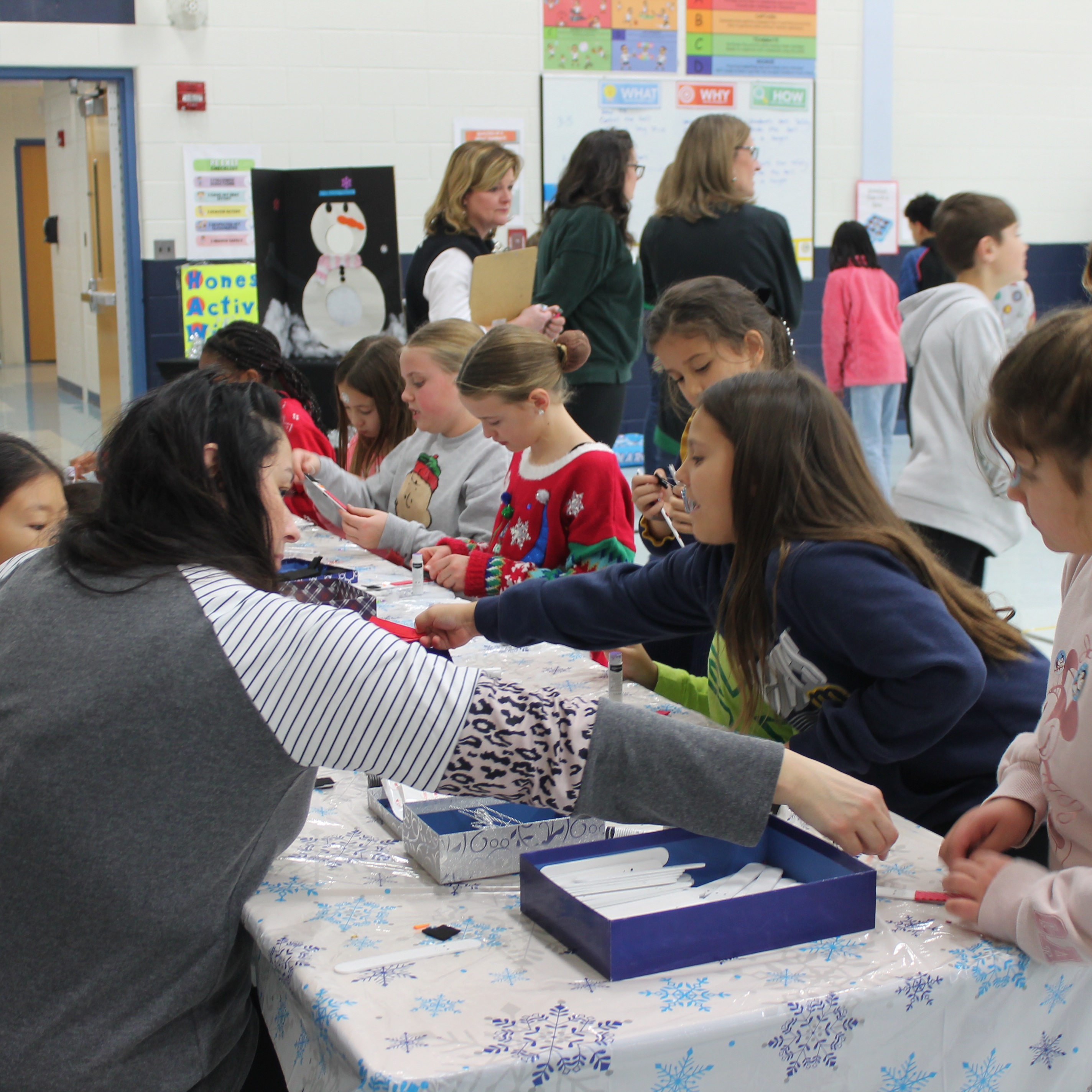 Students enjoy winter-themed crafts at holiday party.