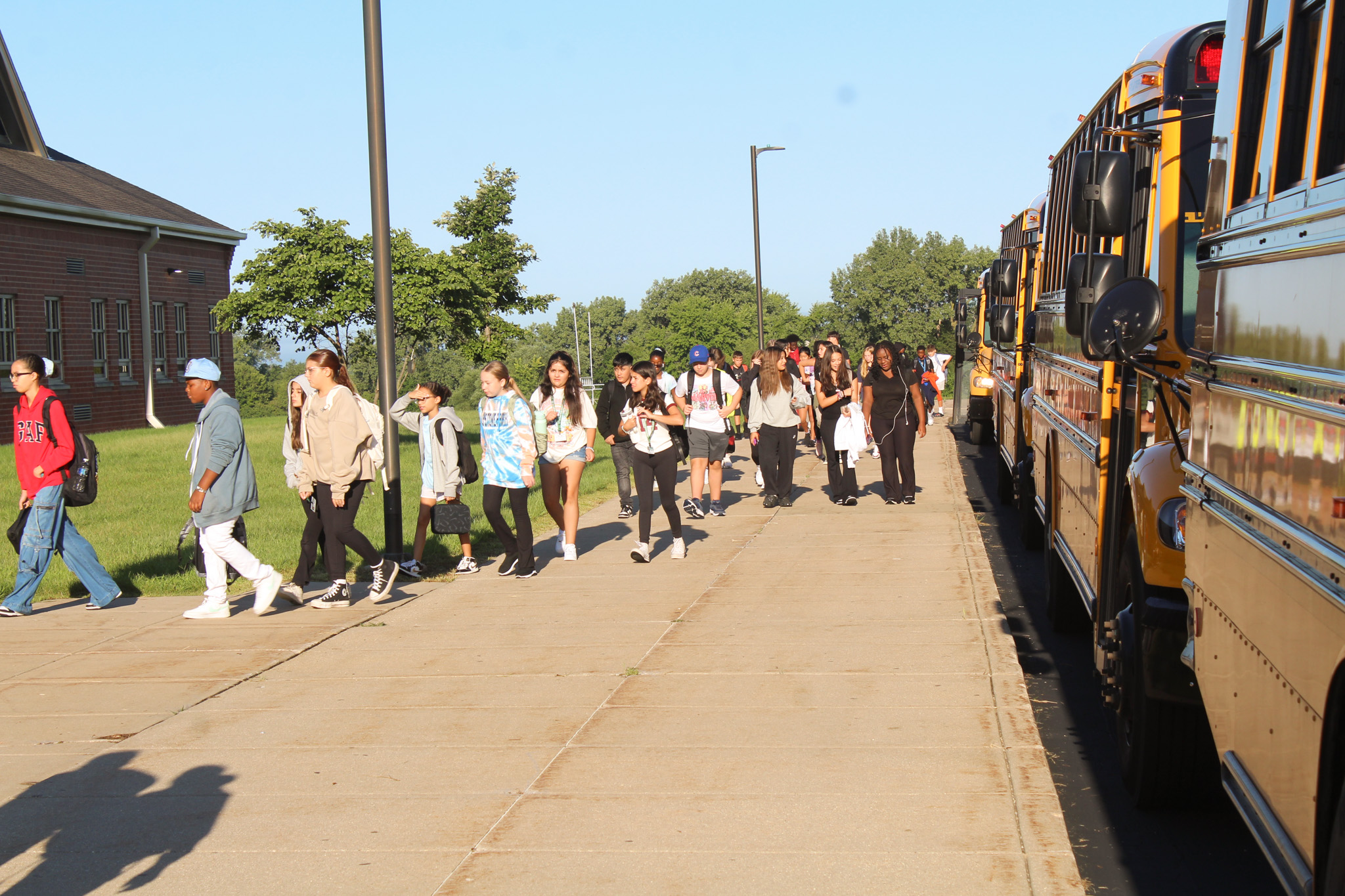 students head into school after getting off bus