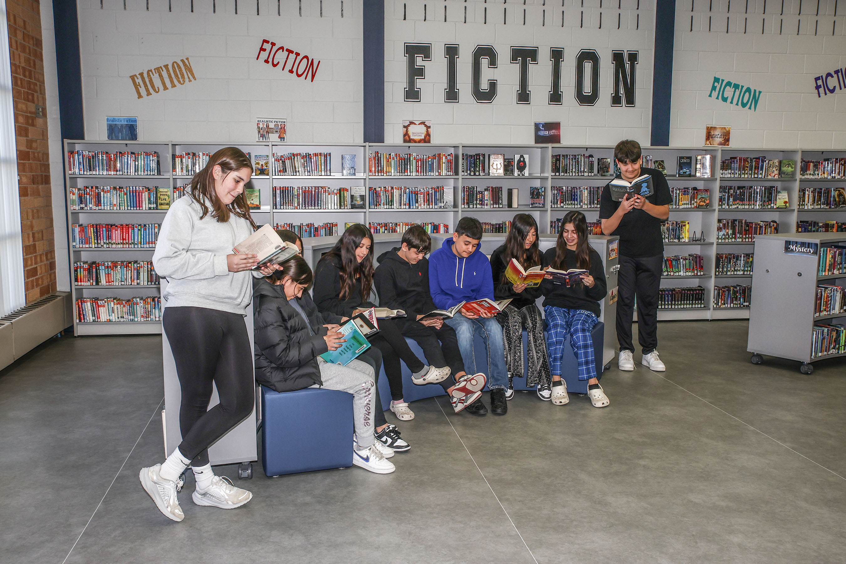 students reading in media center
