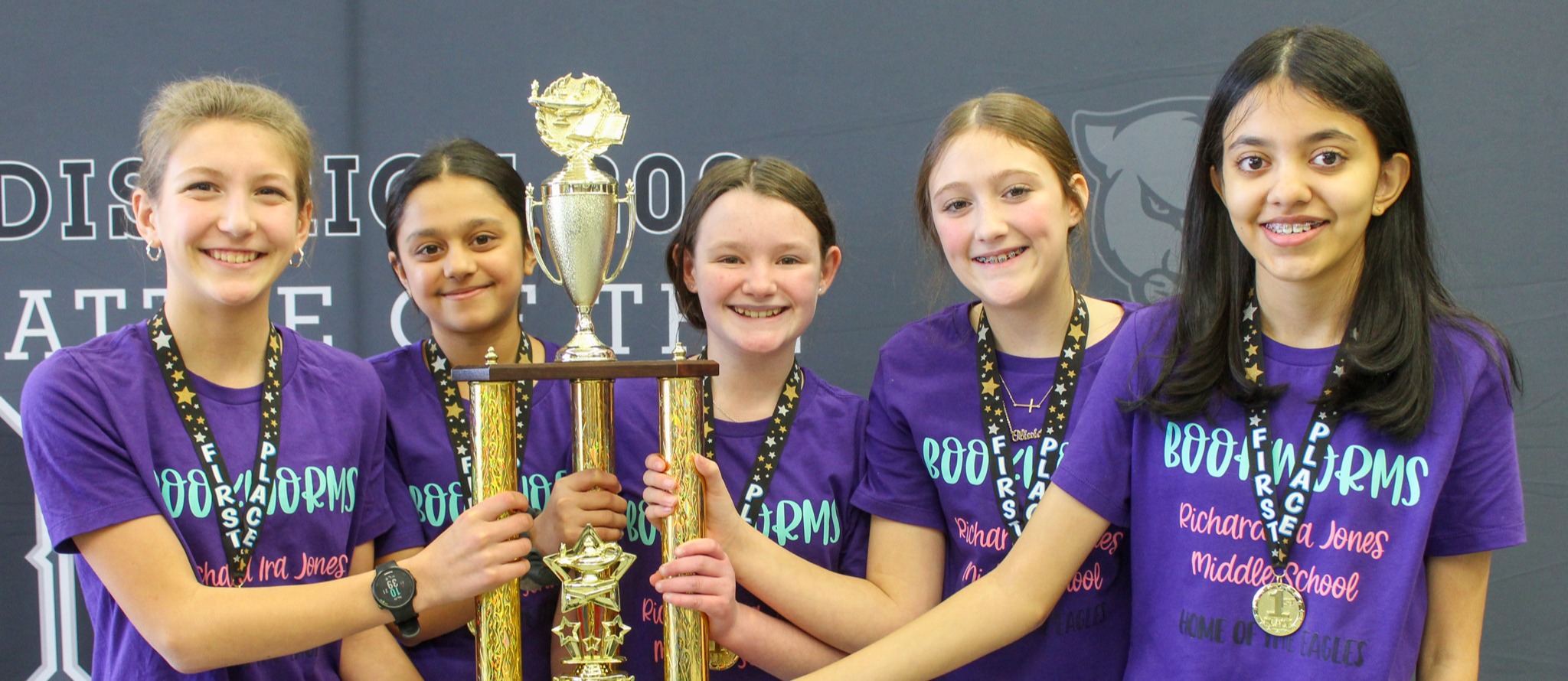 four girls hold battle of the books trophy