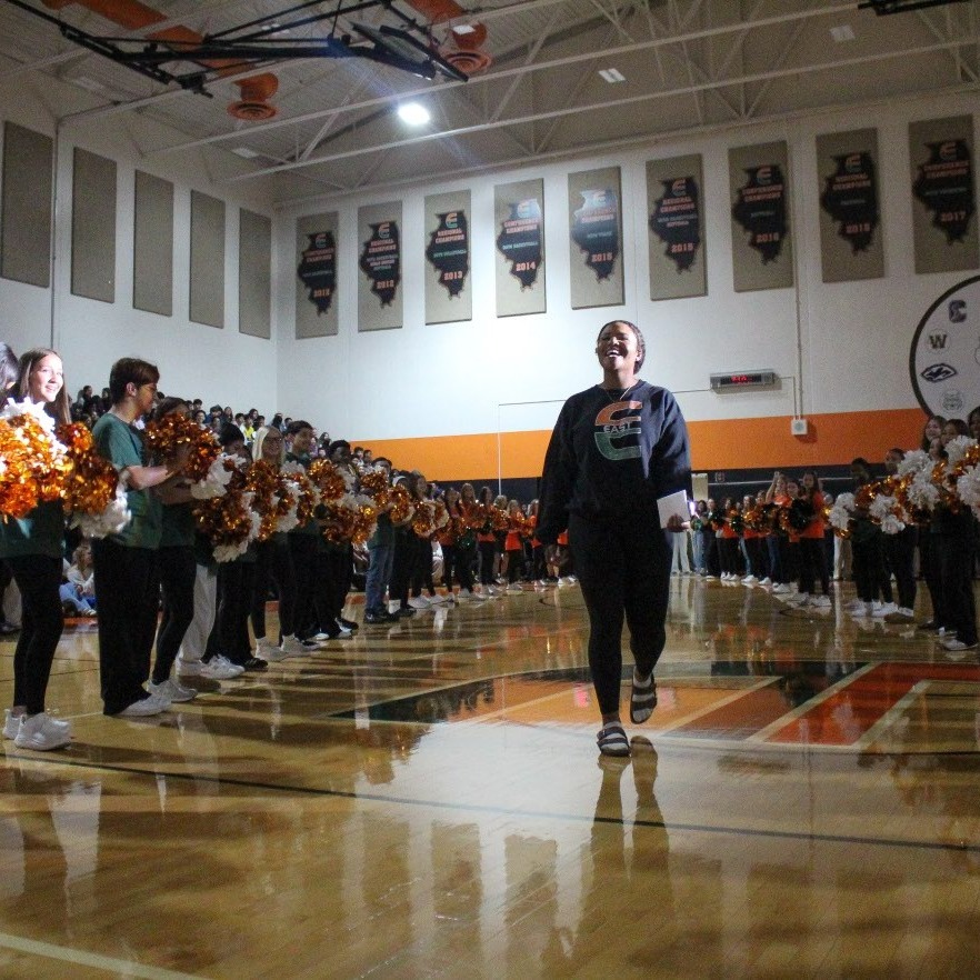 PEHS junior Taylor Miller walks in gym during a pep assembly celebrating her state championship.