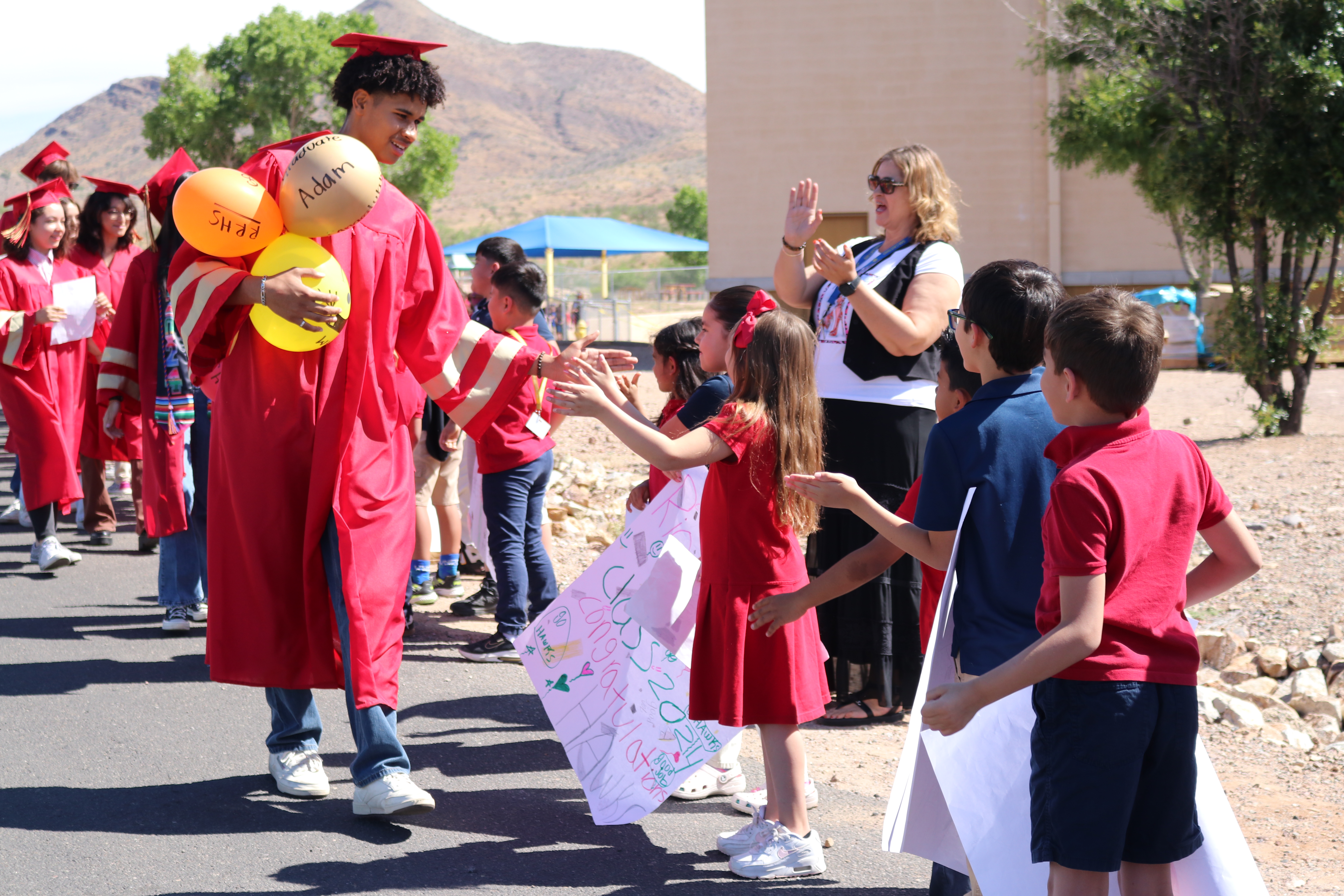 Seniors being congratulated by younger students during the Commit 2 Graduate parade