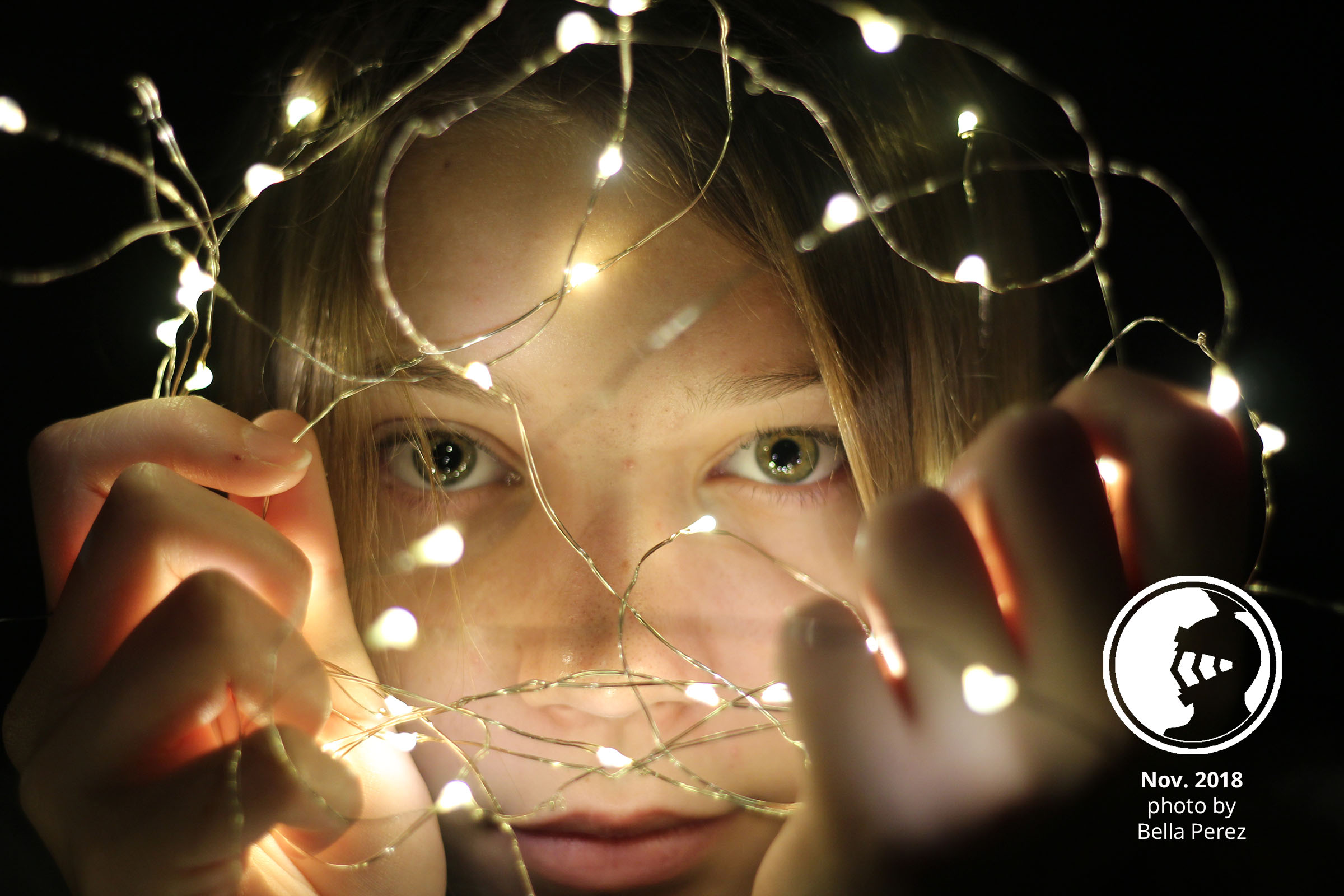 portrait of girl holding fairy lights