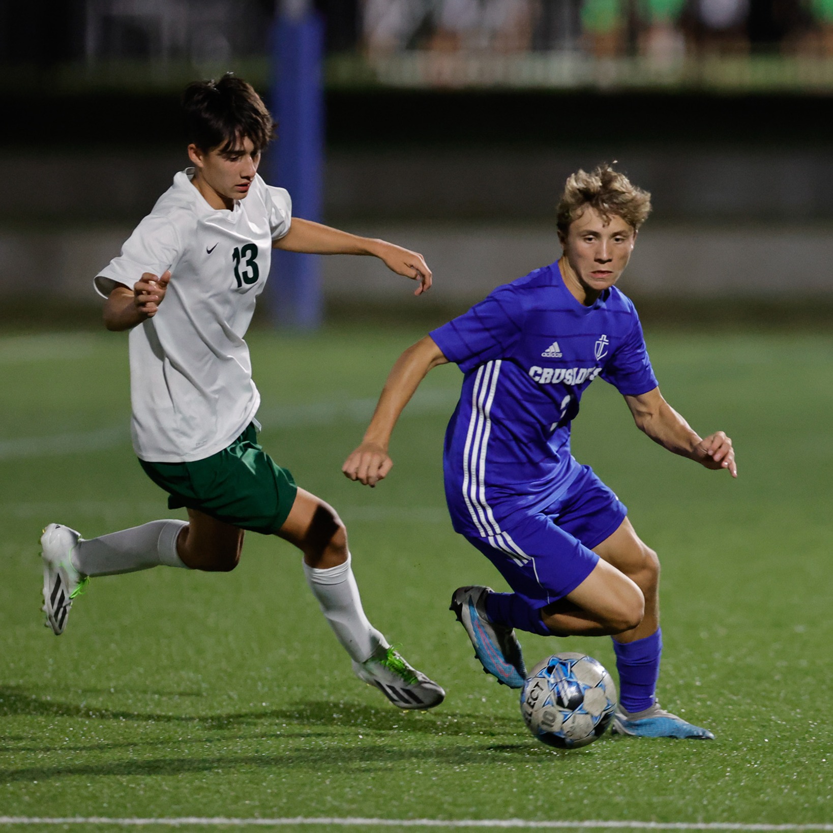 Soccer player dashes around a defender 