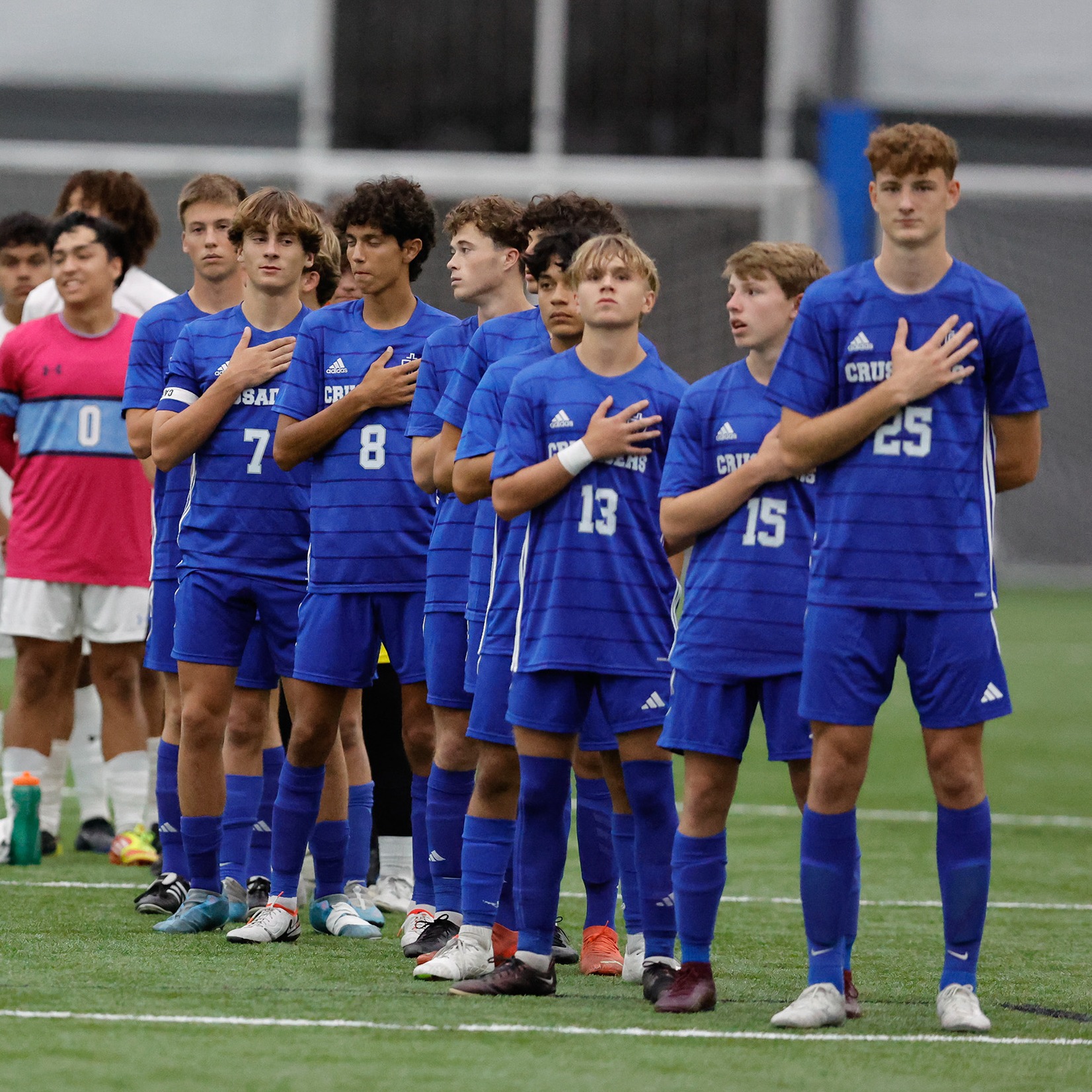 Soccer team stands for the National Anthem