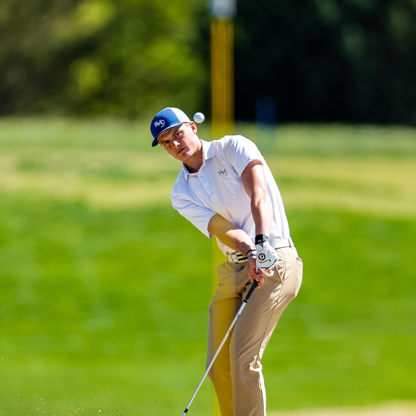 Asher Whitaker takes a swing to get on the green