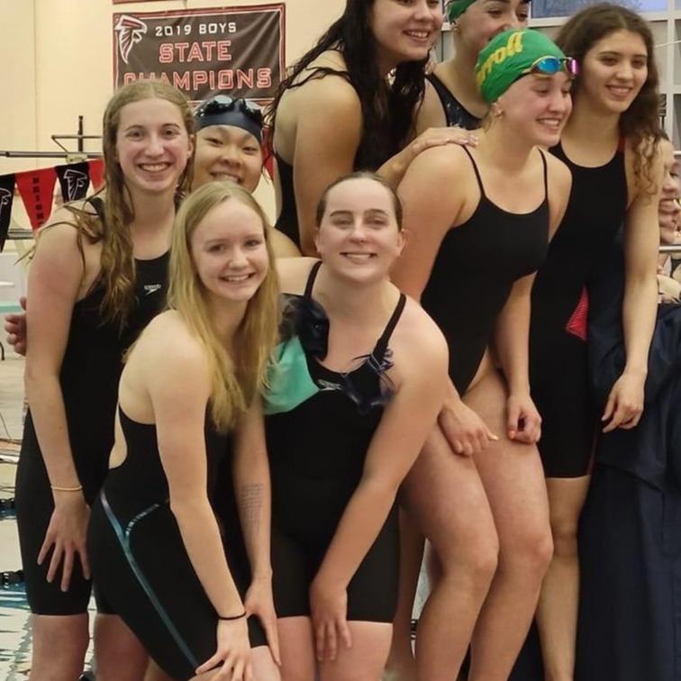 Girls relay team poses for picture on the podium