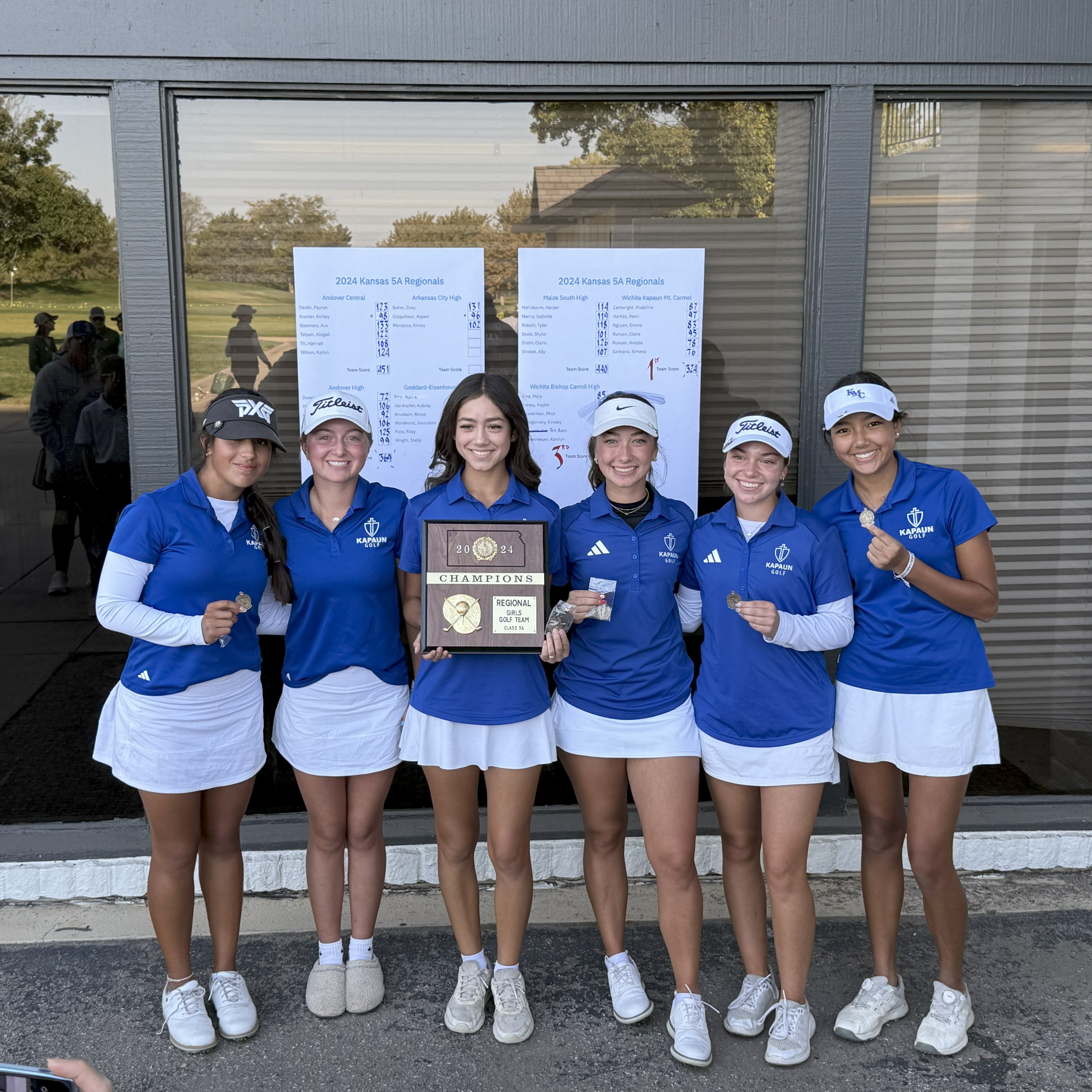 Girls team poses with regional plaque