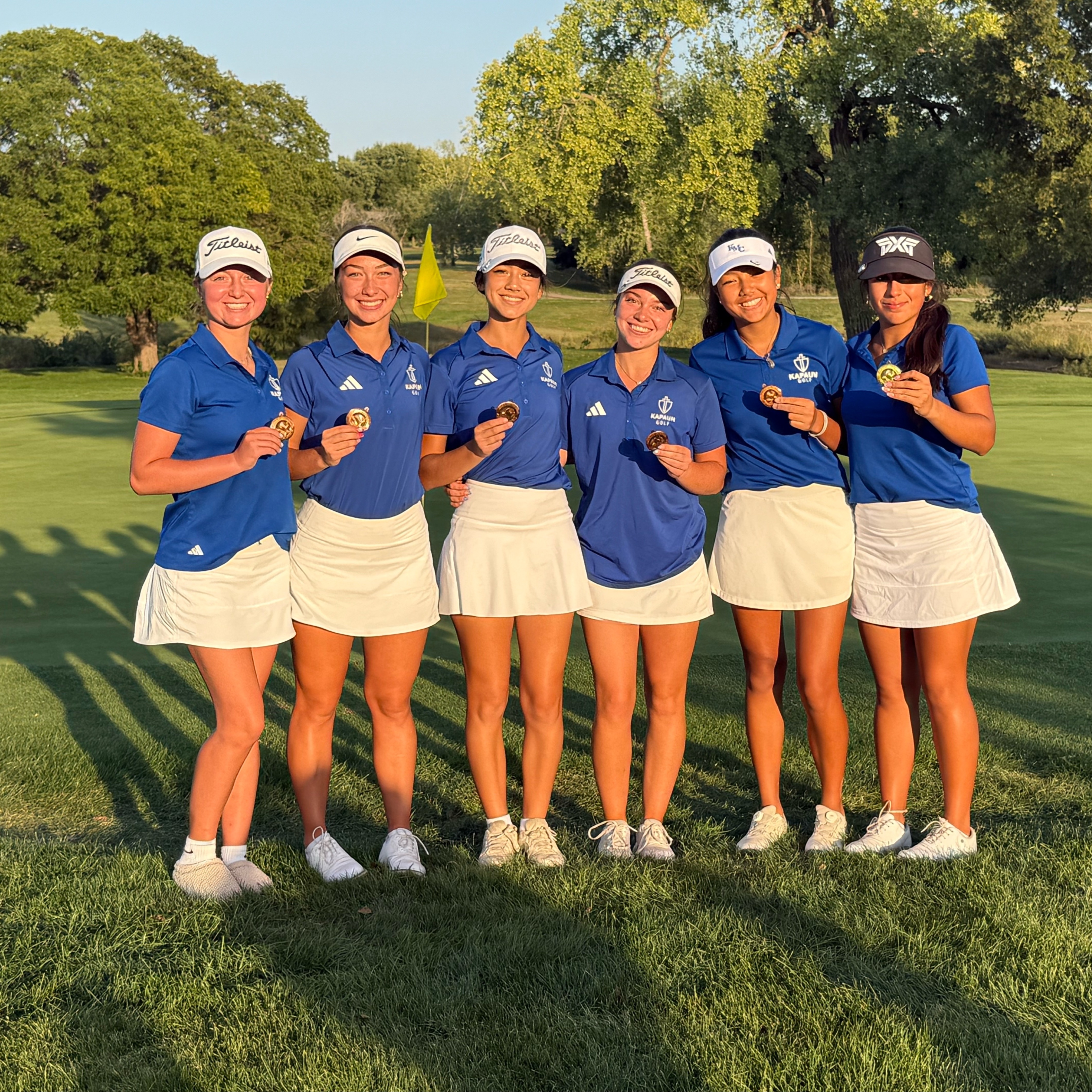 Girls golf team posing after winning city league championship