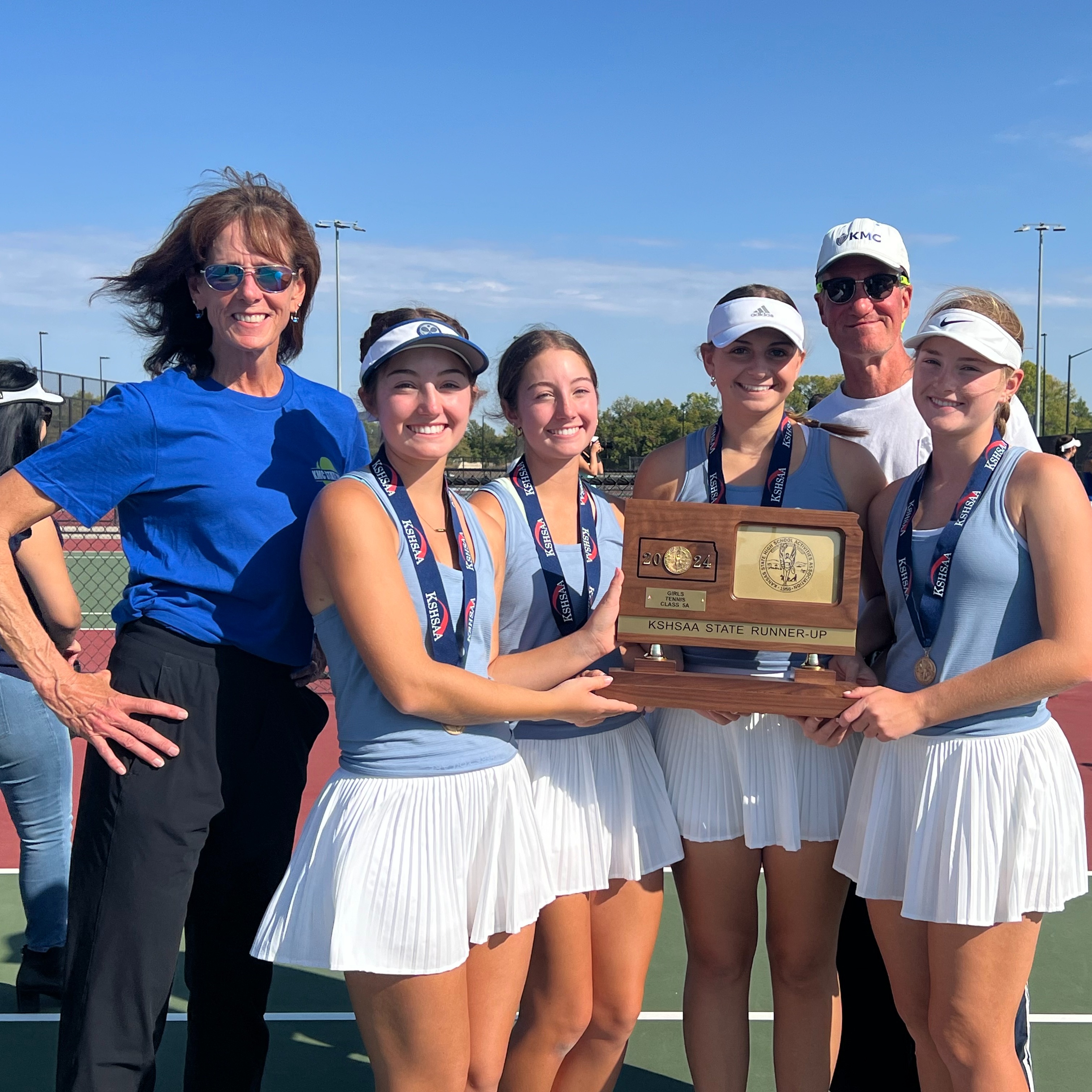 Tennis players and coaches pose after finishing as state runner-up