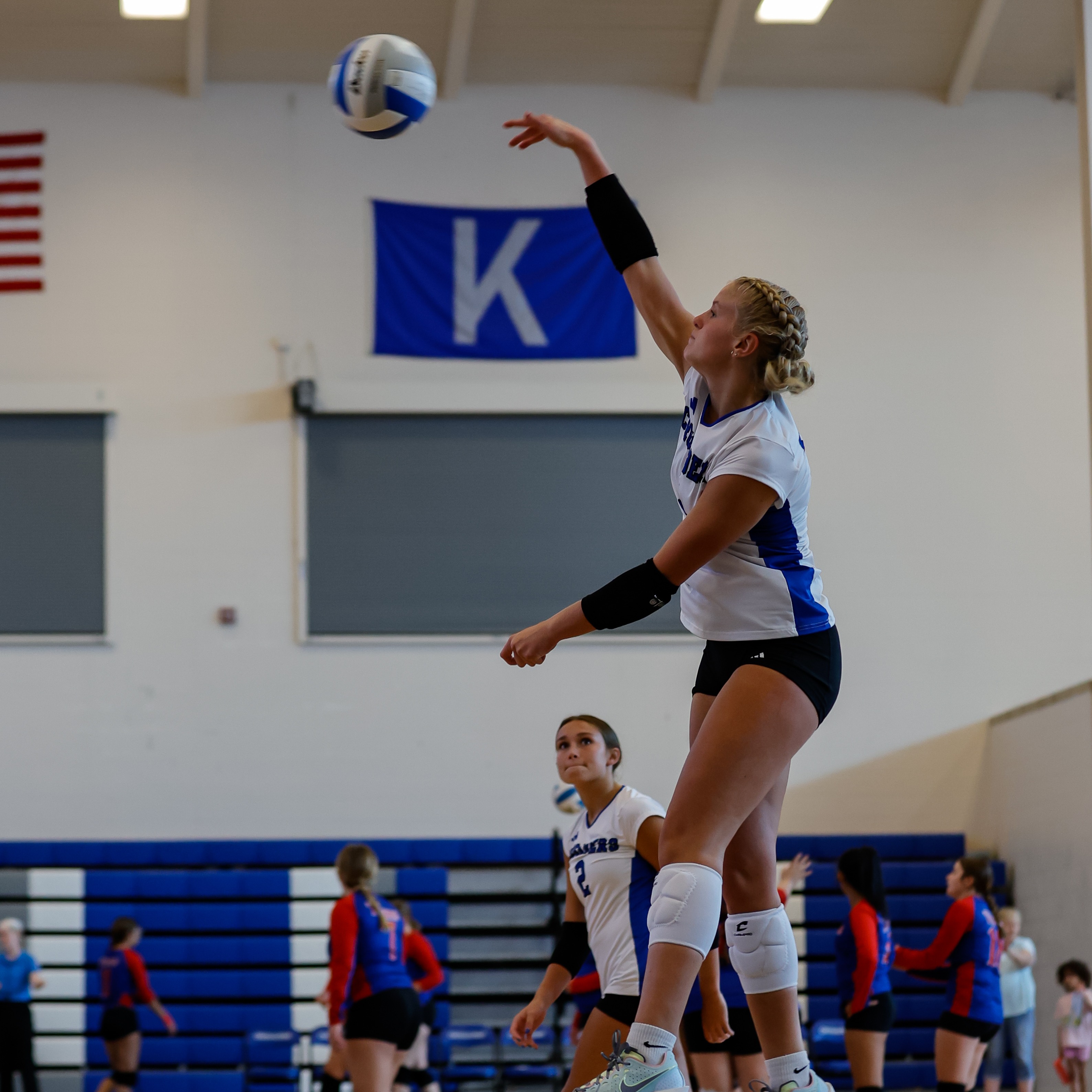 Volleyball player hitting ball