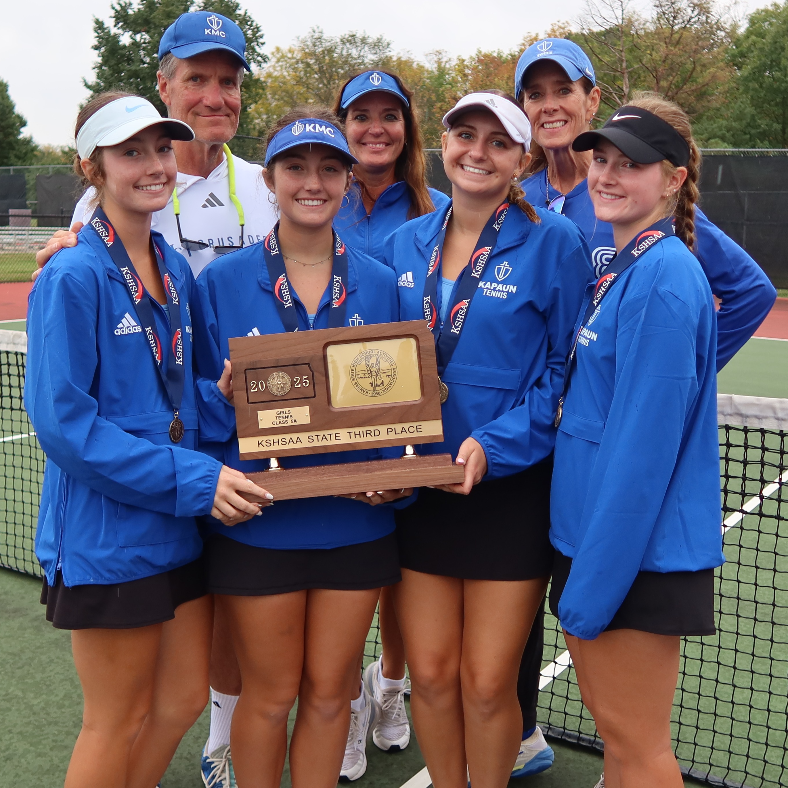 Tennis players and coaches pose after finishing in third at state