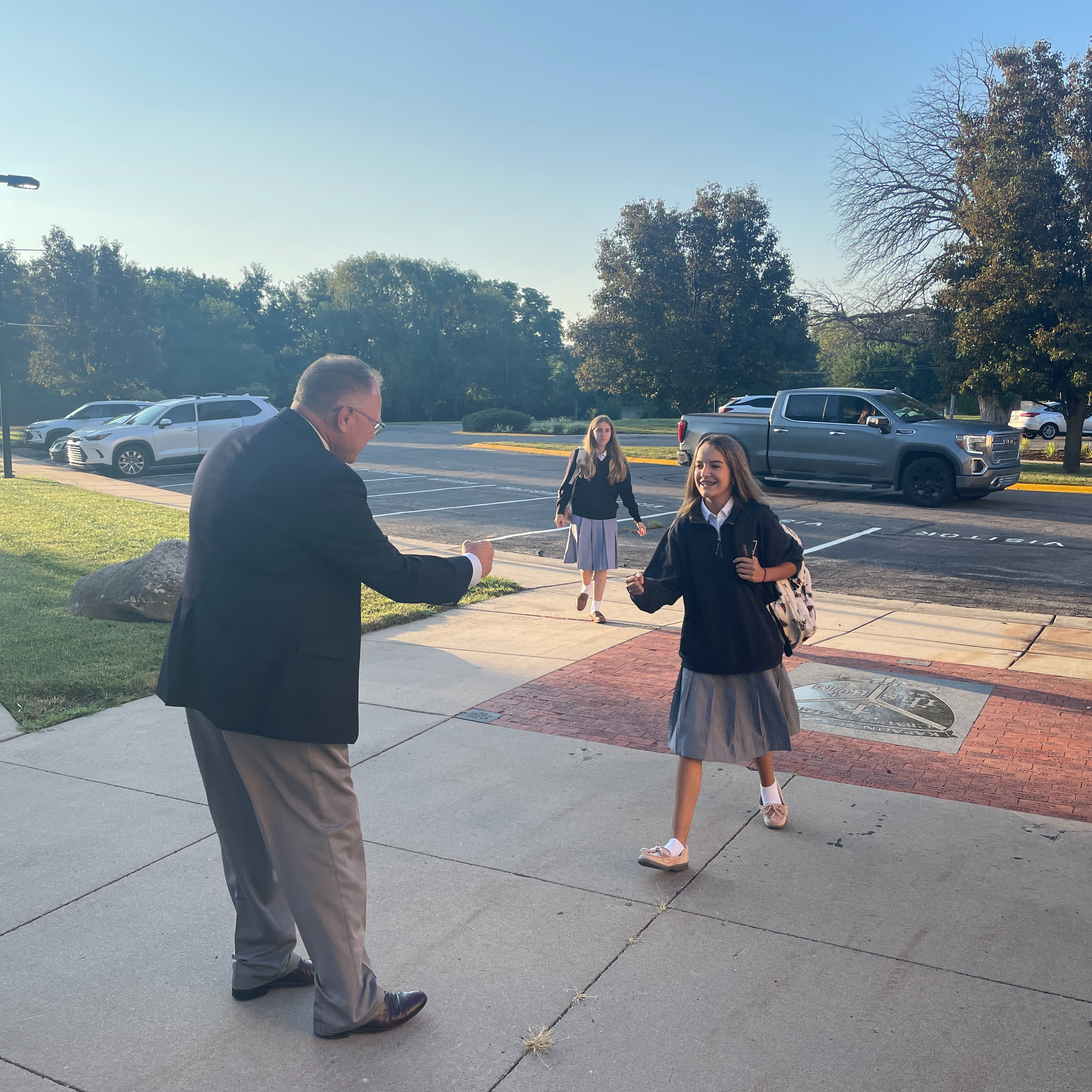 Students being welcomed by Mr. Bloomer