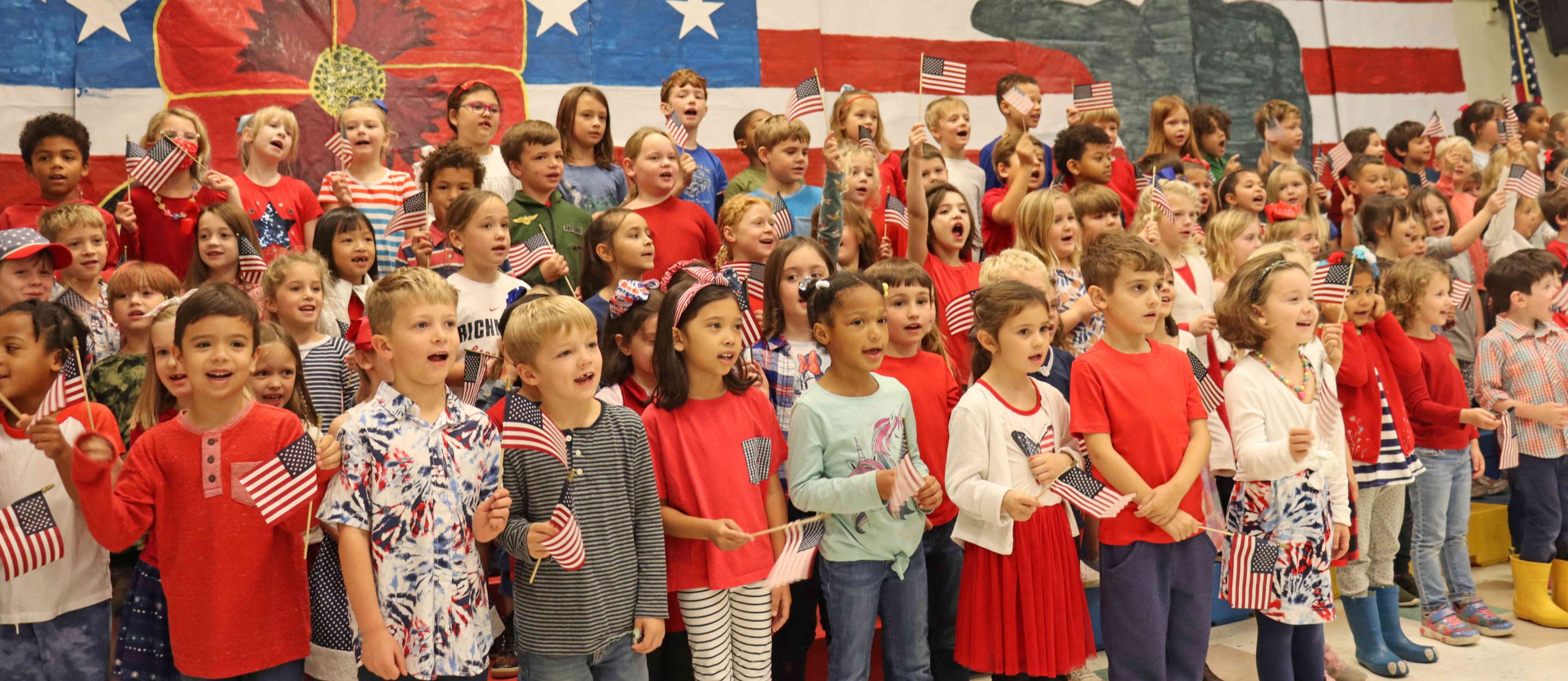 A group of students singing during a Veterans Day event