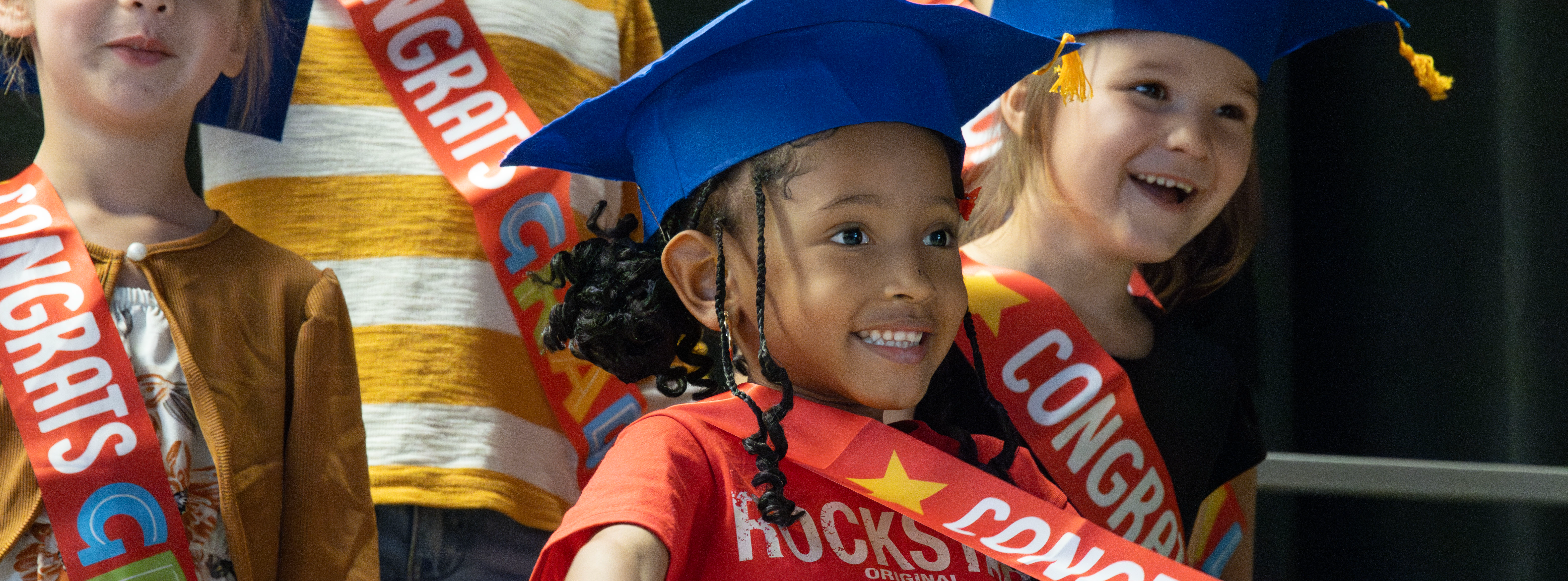 student smiling during prek graduation