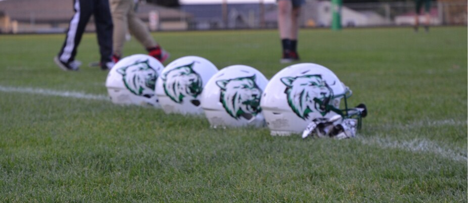 Helmets on the field with the district logo on them