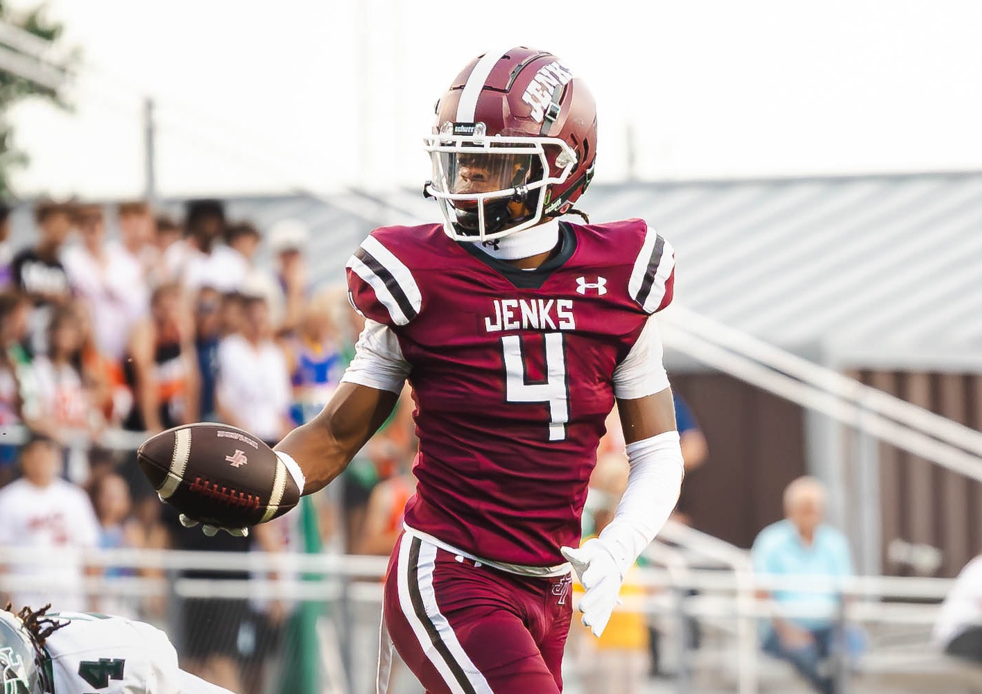 football player holding football