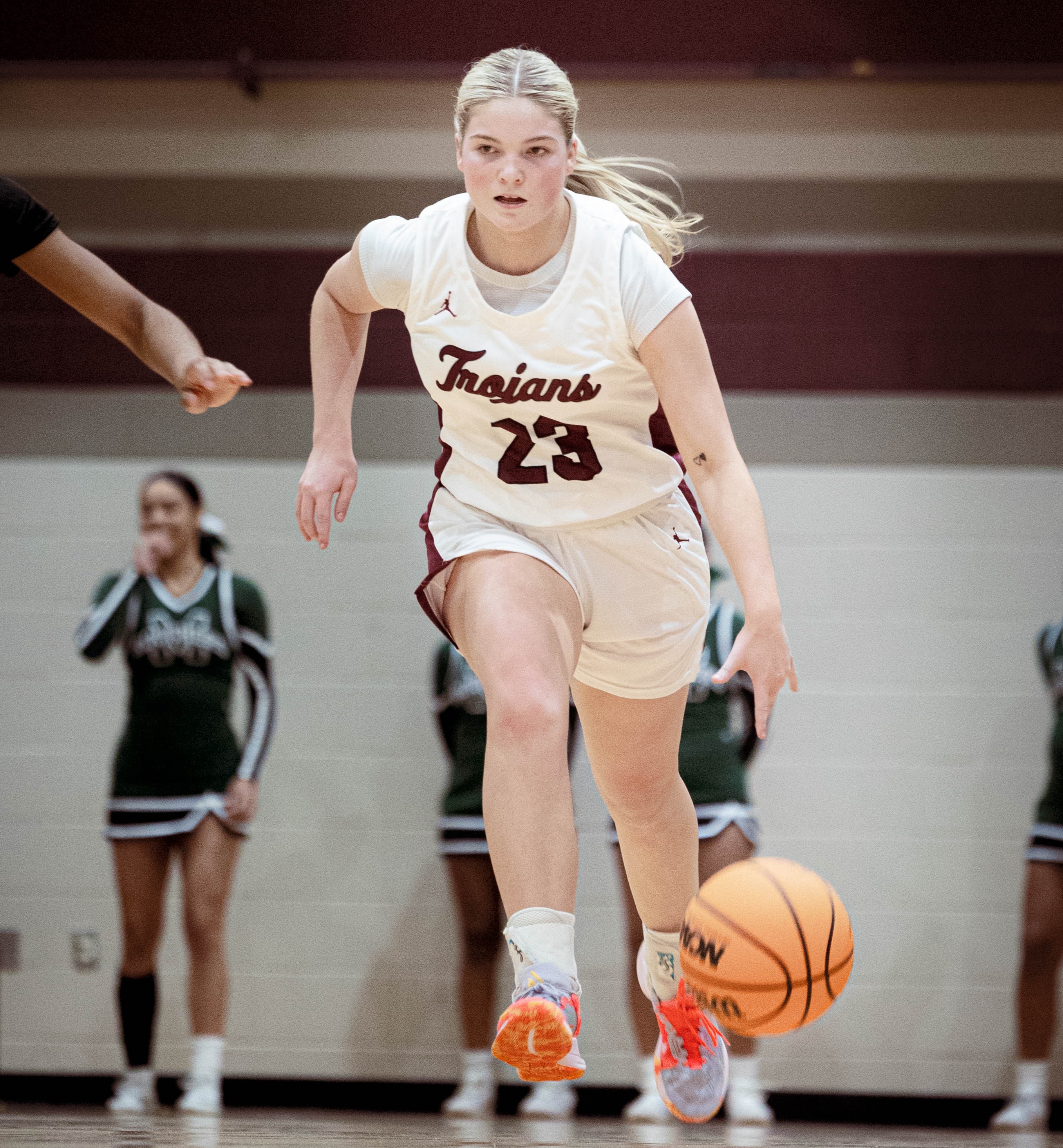 girl dribbling basketball