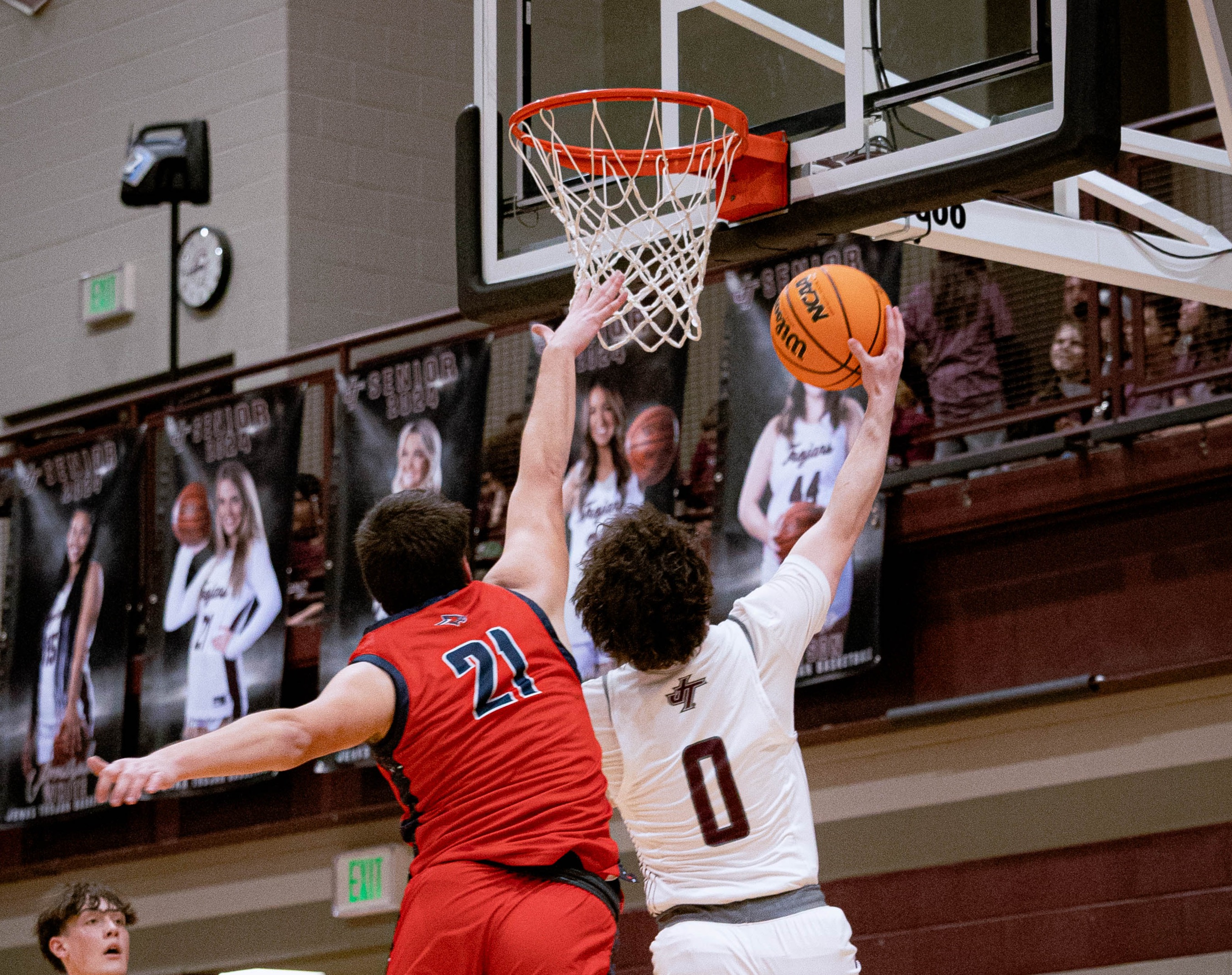 boy shooting basketball