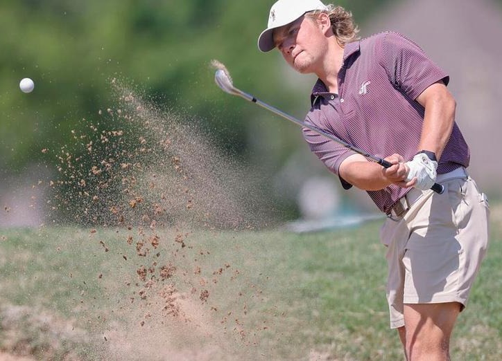 boy hitting golf ball